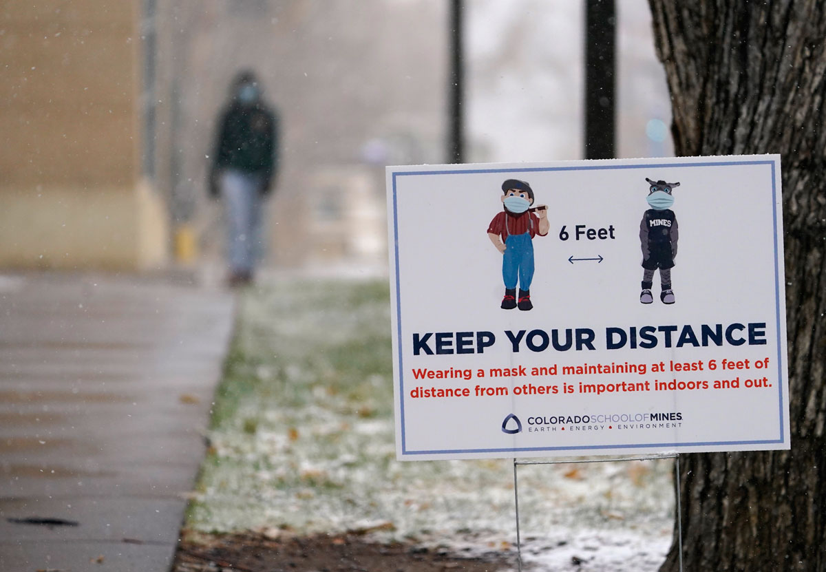 A sign reminds students, faculty and visitors to maintain social distance to combat the spread of the coronavirus while on the campus of the Colorado School of Mines, in Golden, Colorado, on November 9.