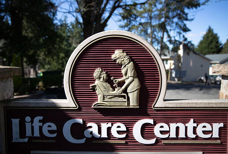 A sign stands at the front entrance of the Life Care Center nursing home on Monday, March 09, 2020 in Kirkland, Washington.