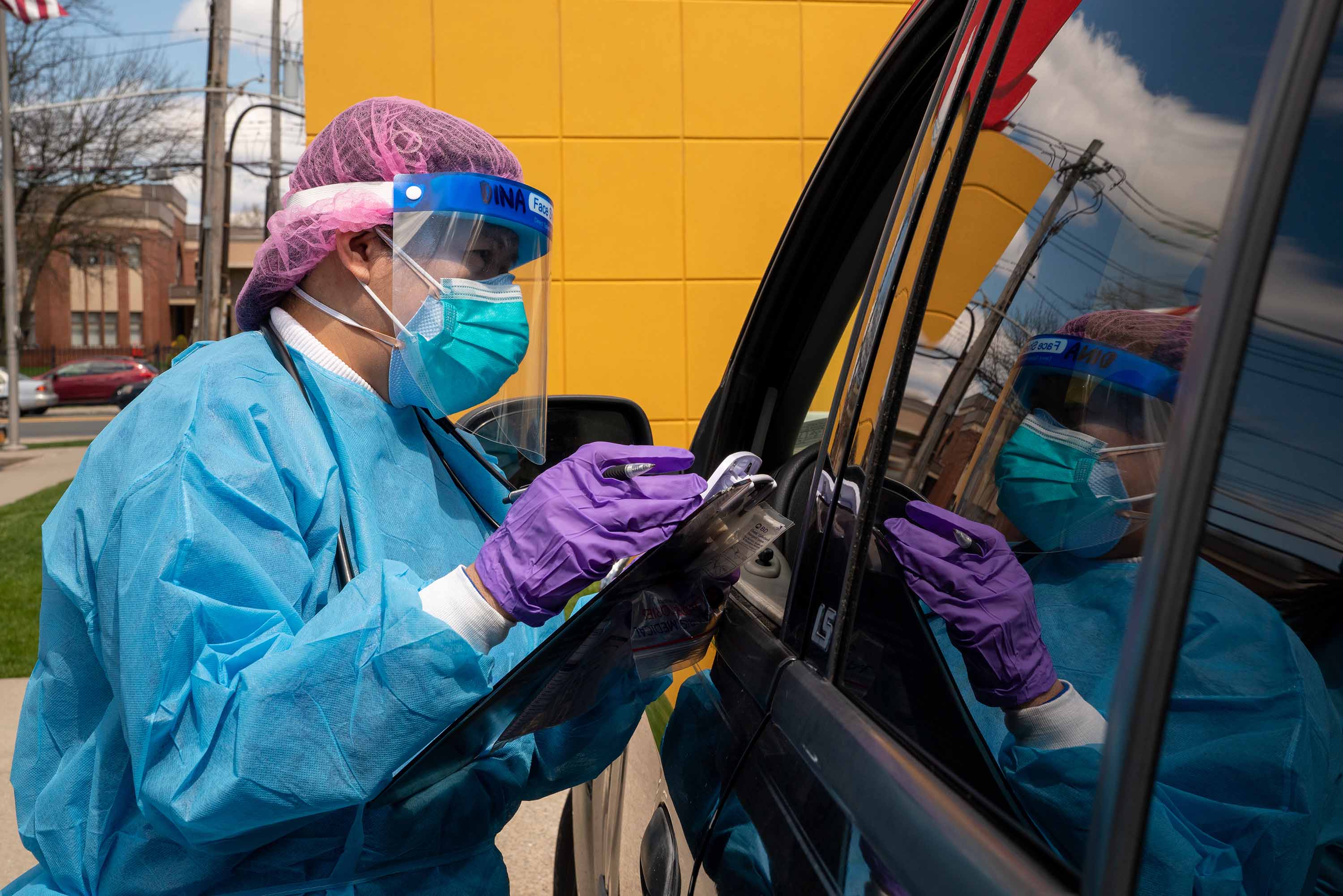 A member of the medical staff at ProHEALTH Care Circle urgent care clinic performs coronavirus testing in the parking lot of their clinic in Staten Island, New York on April 22.