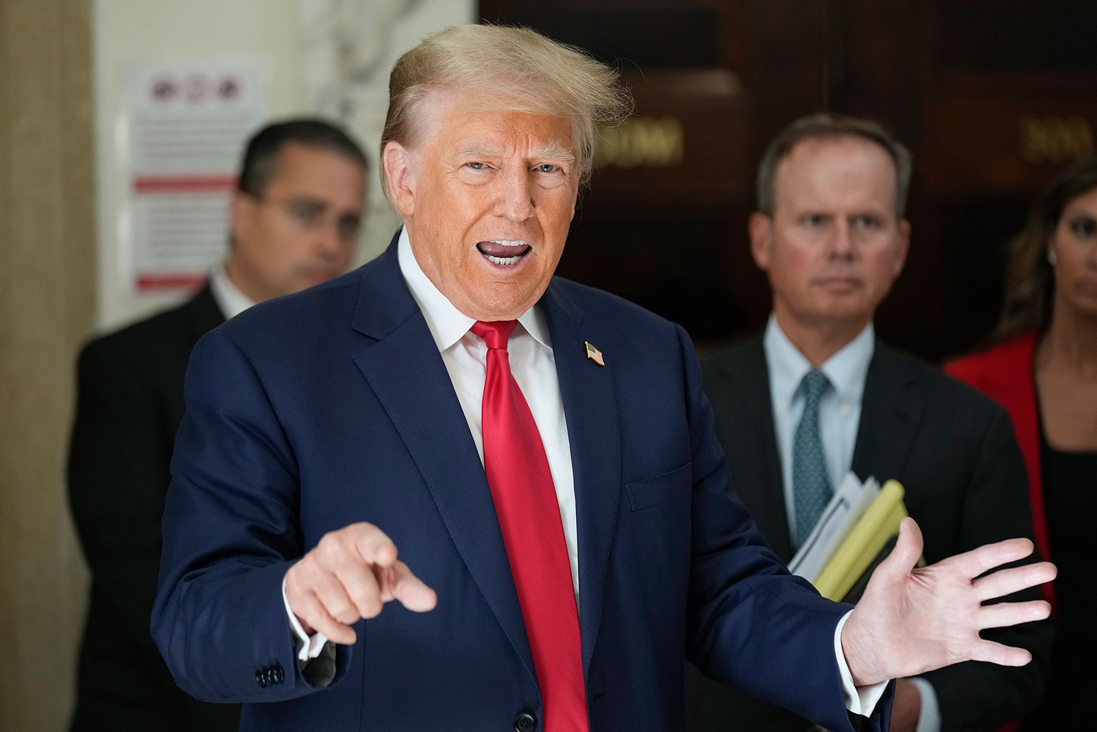 Former President Donald Trump speaks to the media during a break in his civil fraud trial in New York on Tuesday.