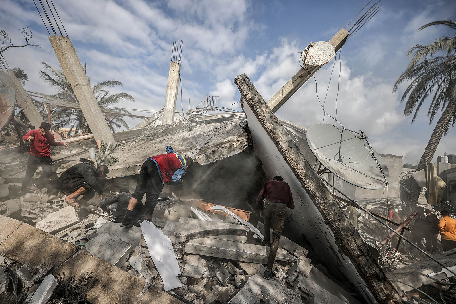 Civil defense teams and Palestinians conduct search and rescue operations in destroyed buidings in Rafah, Gaza on Thursday, December 14. 