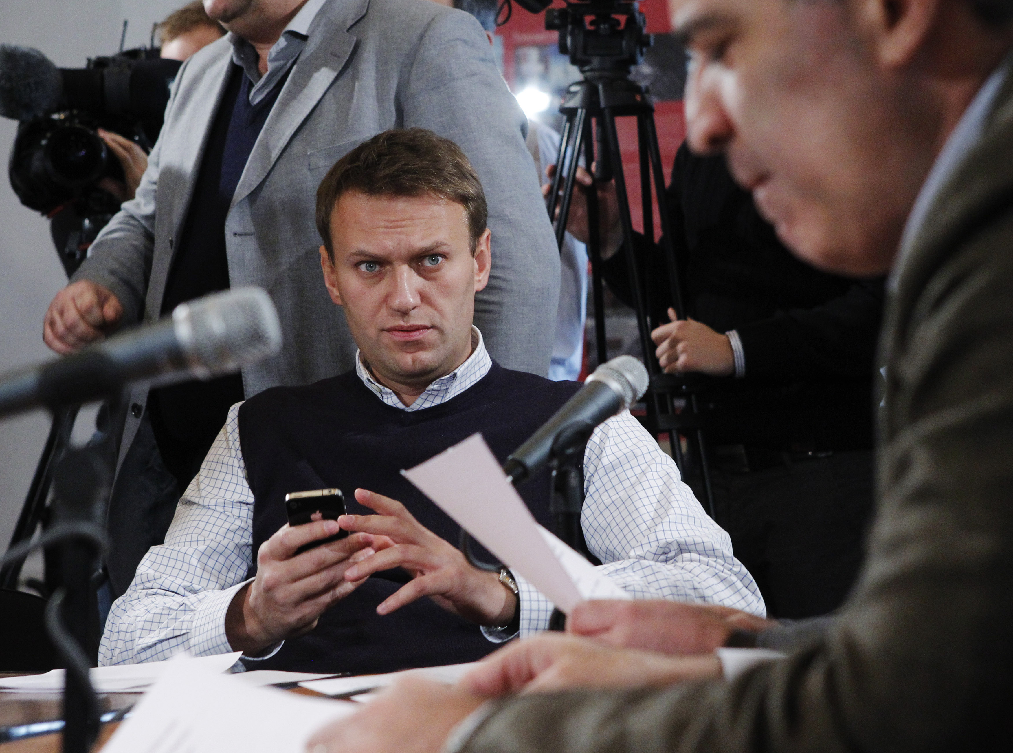 Navalny listens to opposition leader Garry Kasparov as a committee meets in January 2012 to discuss a new protest in Moscow.