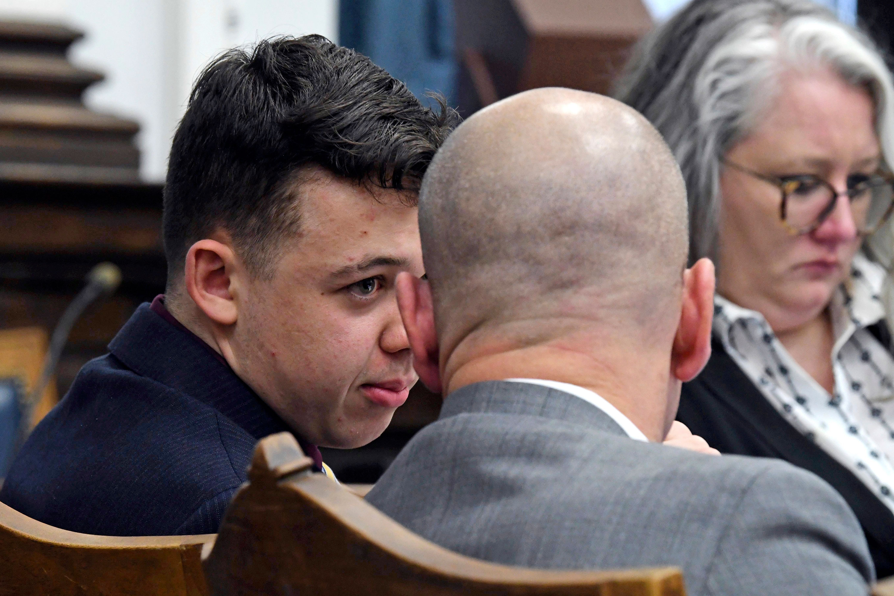 Kyle Rittenhouse, left, and defense attorney Corey Chirafisi confer during Rittenhouse's trial in Kenosha, Wisconsin, on Thursday.