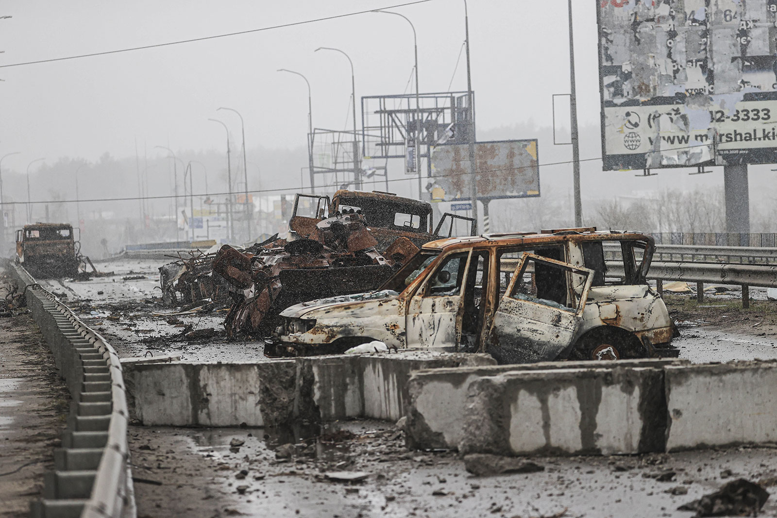 Damaged vehicles are seen in the Hostomel region on April 03. 