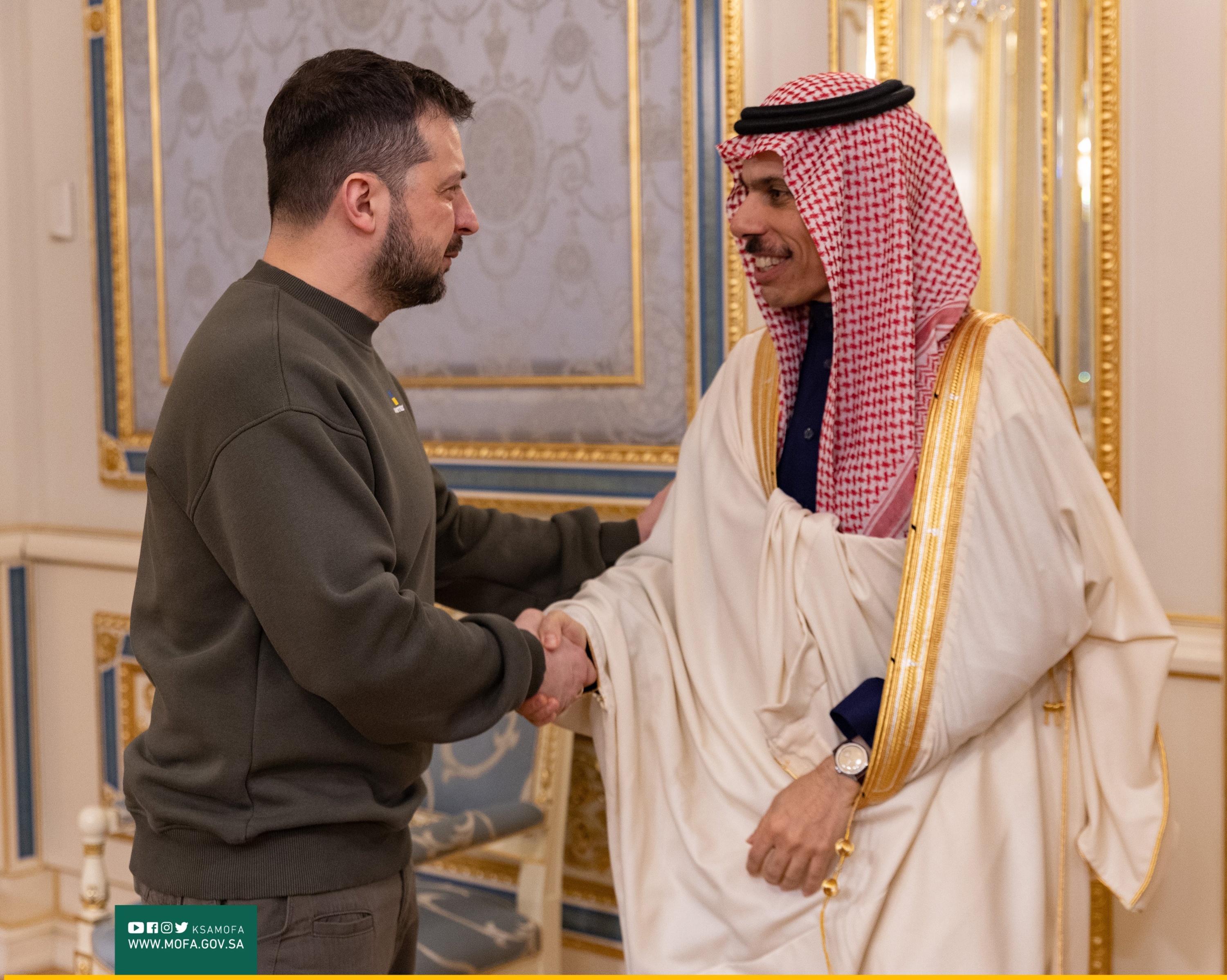 Ukrainian President Volodymyr Zelensky, left, shakes hands with Saudi Arabia's Prince Faisal bin Farhan Al Saud, on Sunday.