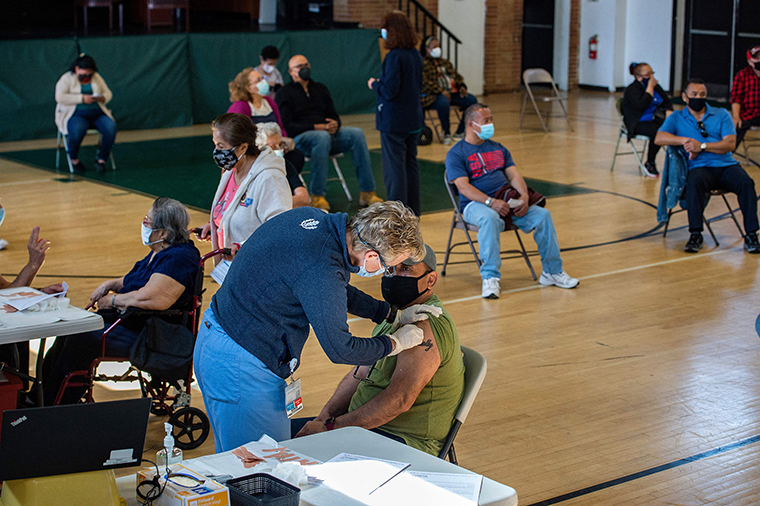 People receive their second dose of the Moderna covid-19 vaccine at a mobile Covid-19 vaccination clinic in Bridgeport, Connecticut on April 20. 