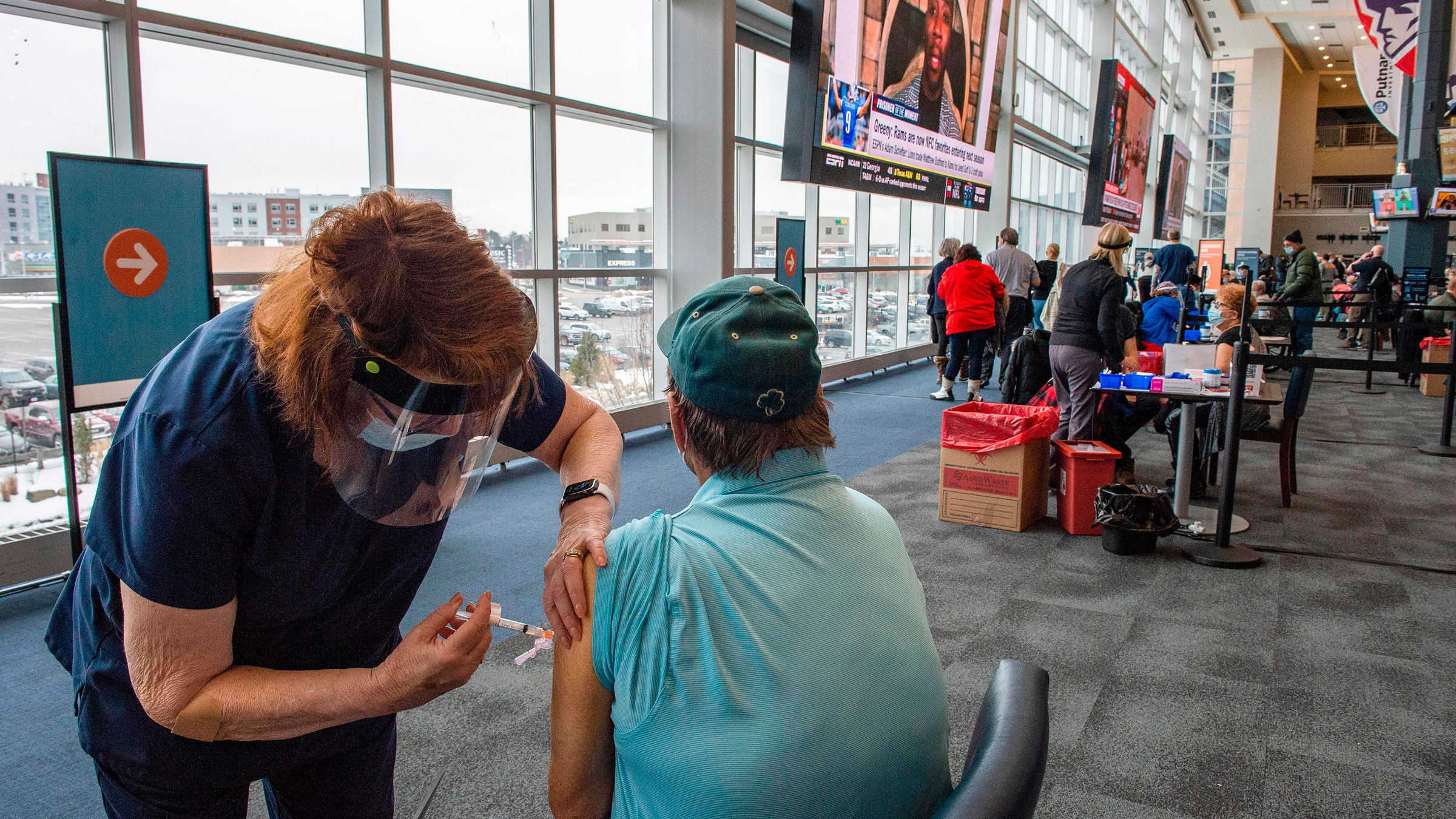 People receive Covid-19 vaccines at Gillette Stadium in Foxborough, Massachusetts, on Monday.