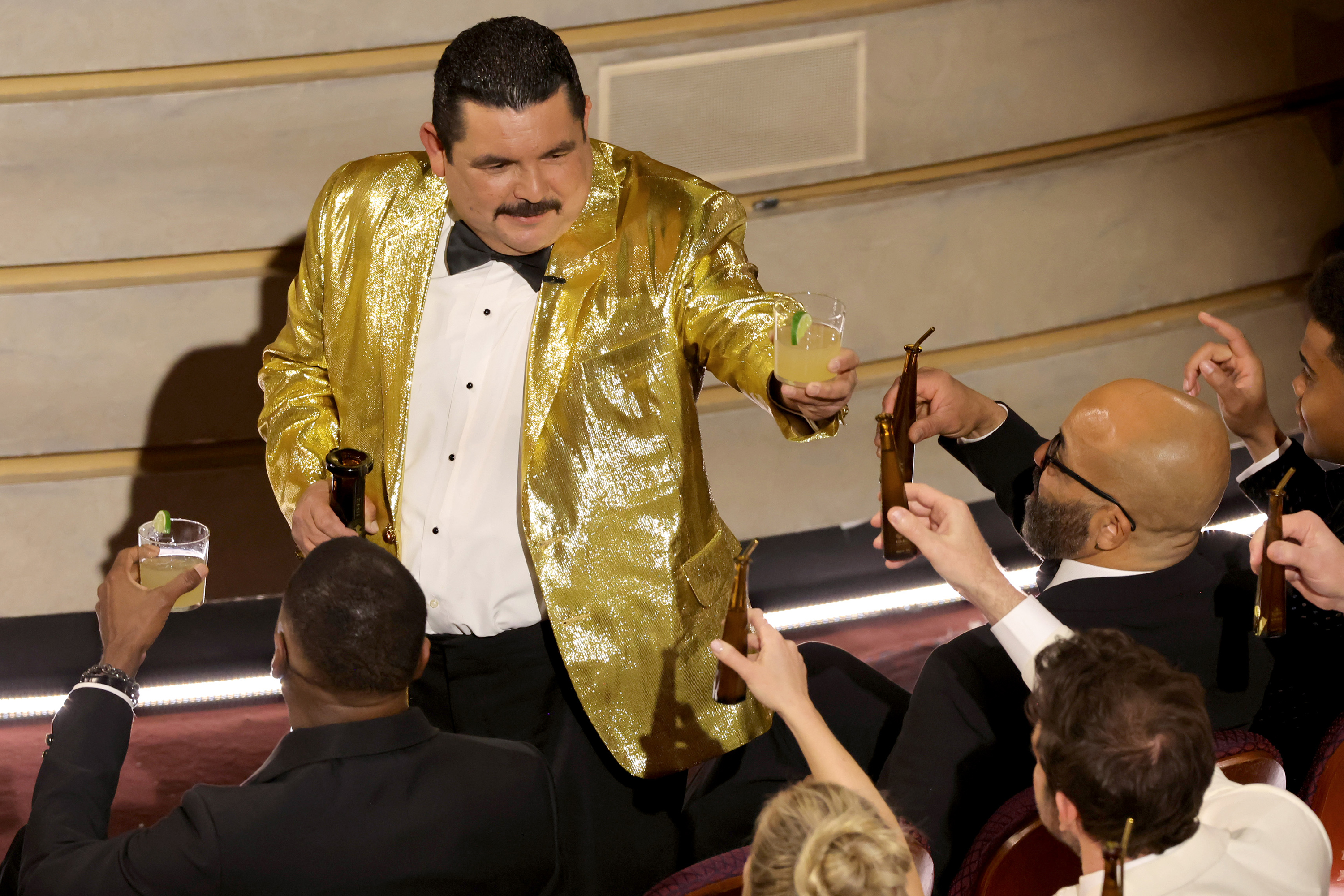 Guillermo Rodriguez toasts people in the crowd. 