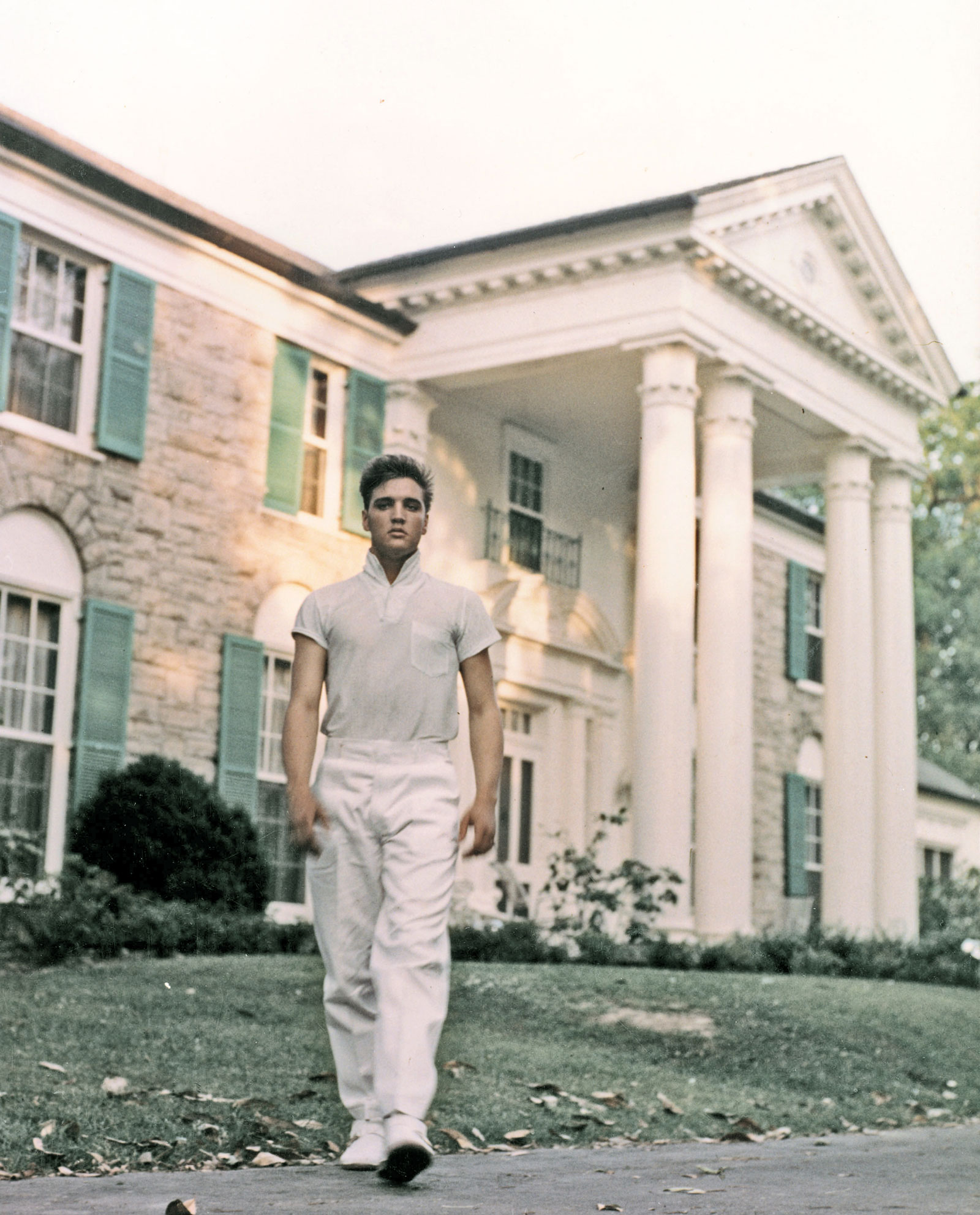 Elvis Presley strolls the grounds of his Graceland estate circa 1957. 