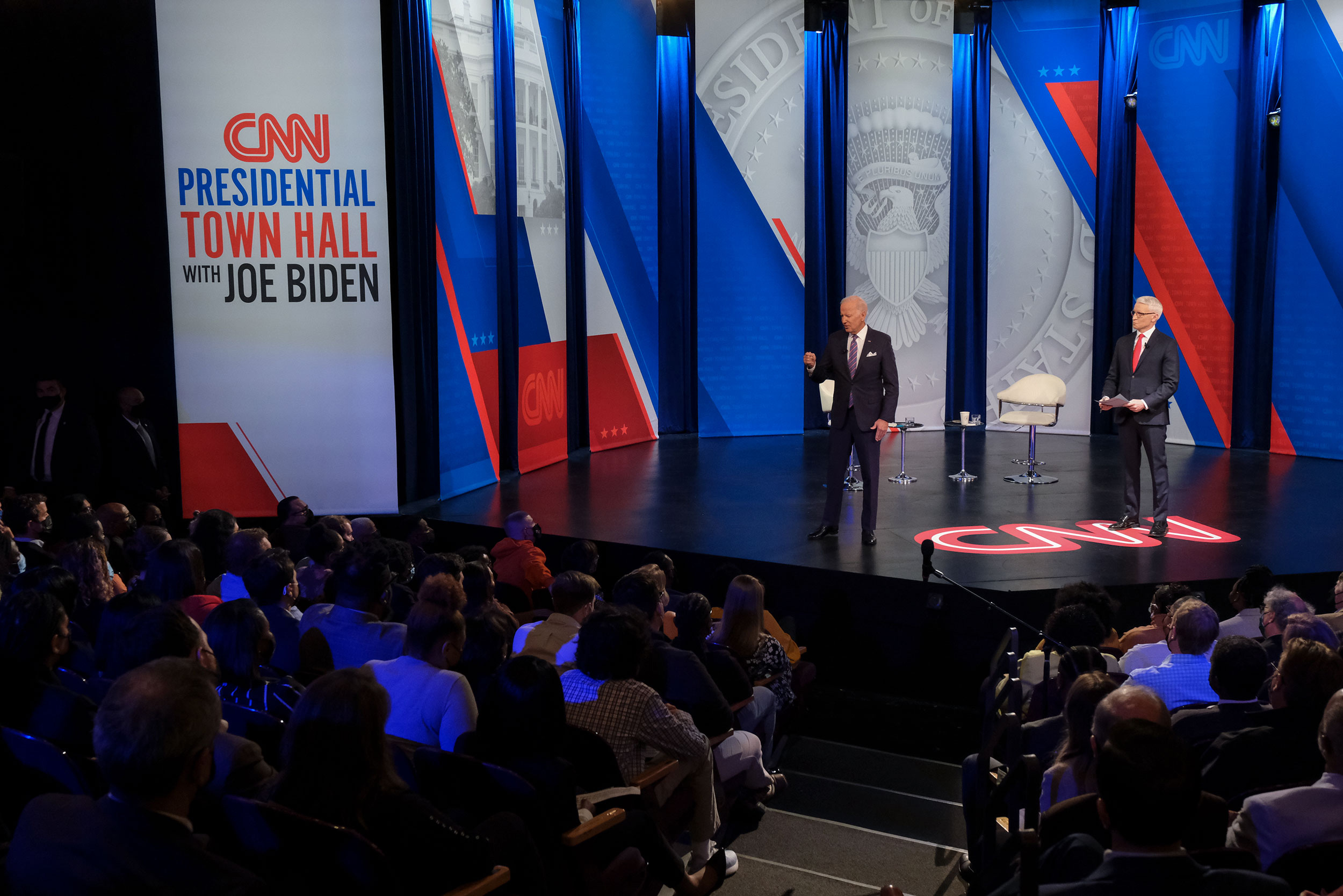 President Joe Biden speaks to the audience while CNN anchor and host Anderson Cooper listens during CNN's Presidential Town Hall in Baltimore, Maryland, on October 21.