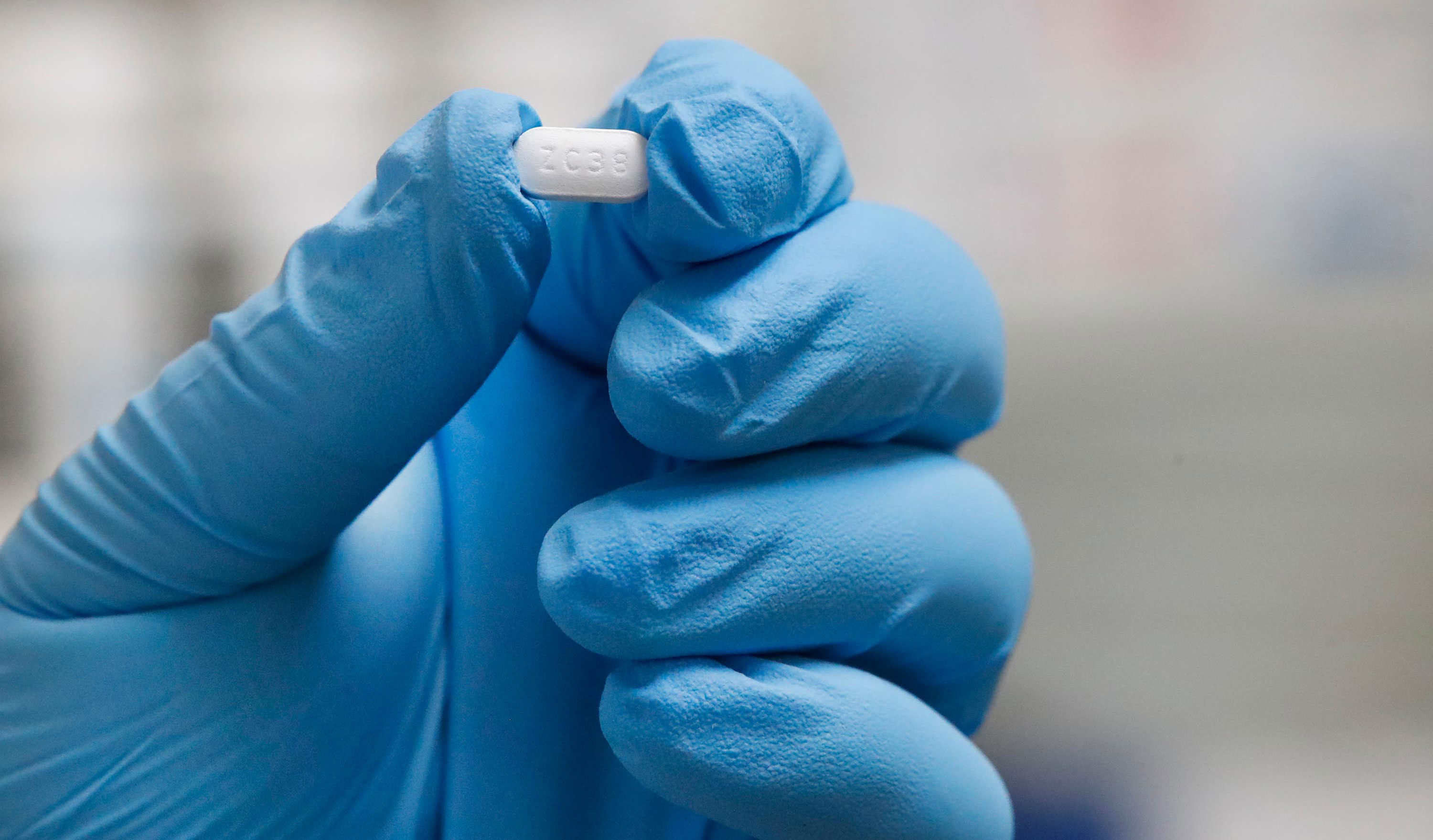 A pharmacy tech holds a Hydroxychloroquine pill at Rock Canyon Pharmacy in Provo, Utah, on May 20. 