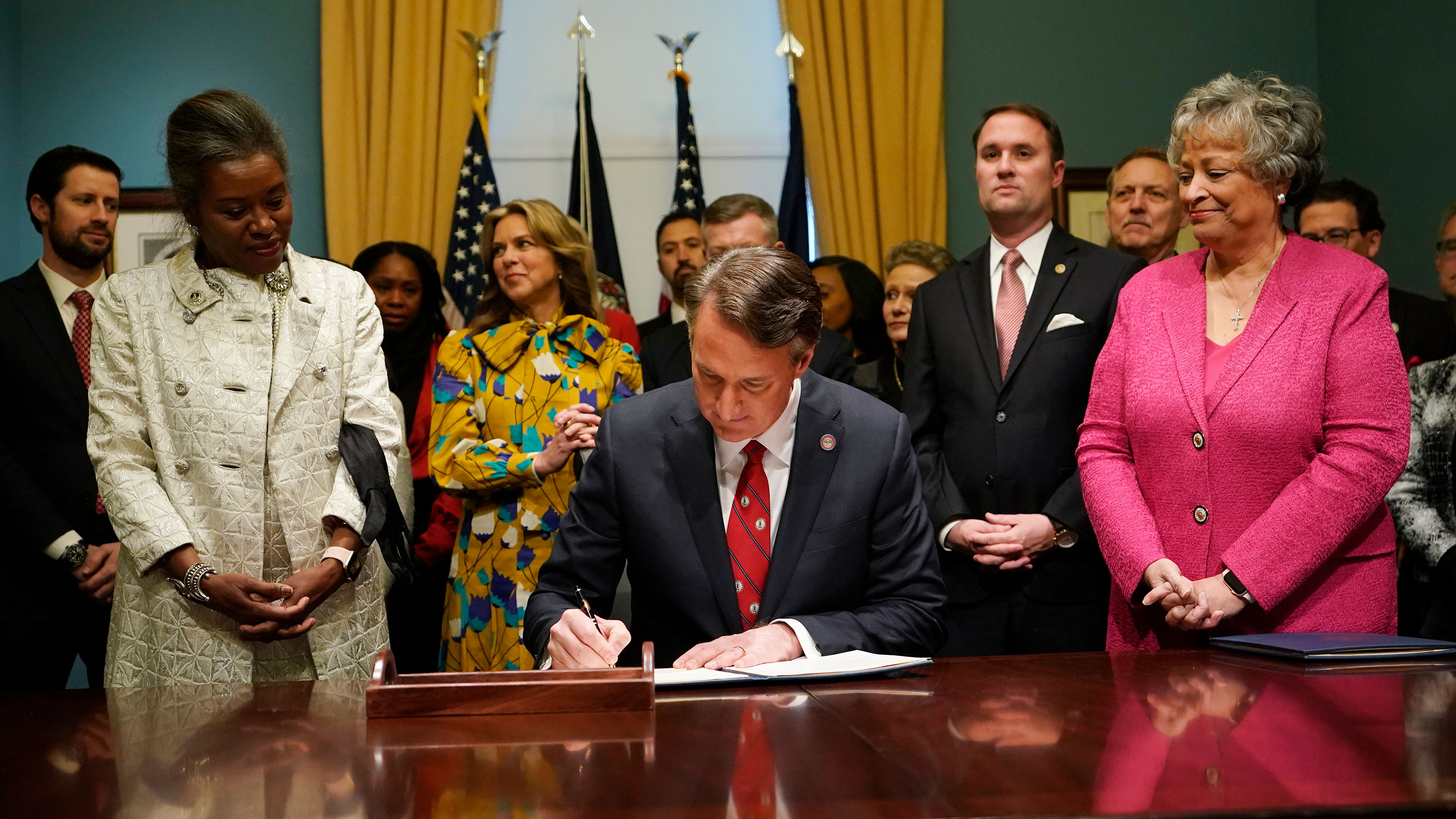 Virginia Gov. Glenn Youngkin signs executive orders in Richmond, Virginia, after being sworn in as governor on January 15.