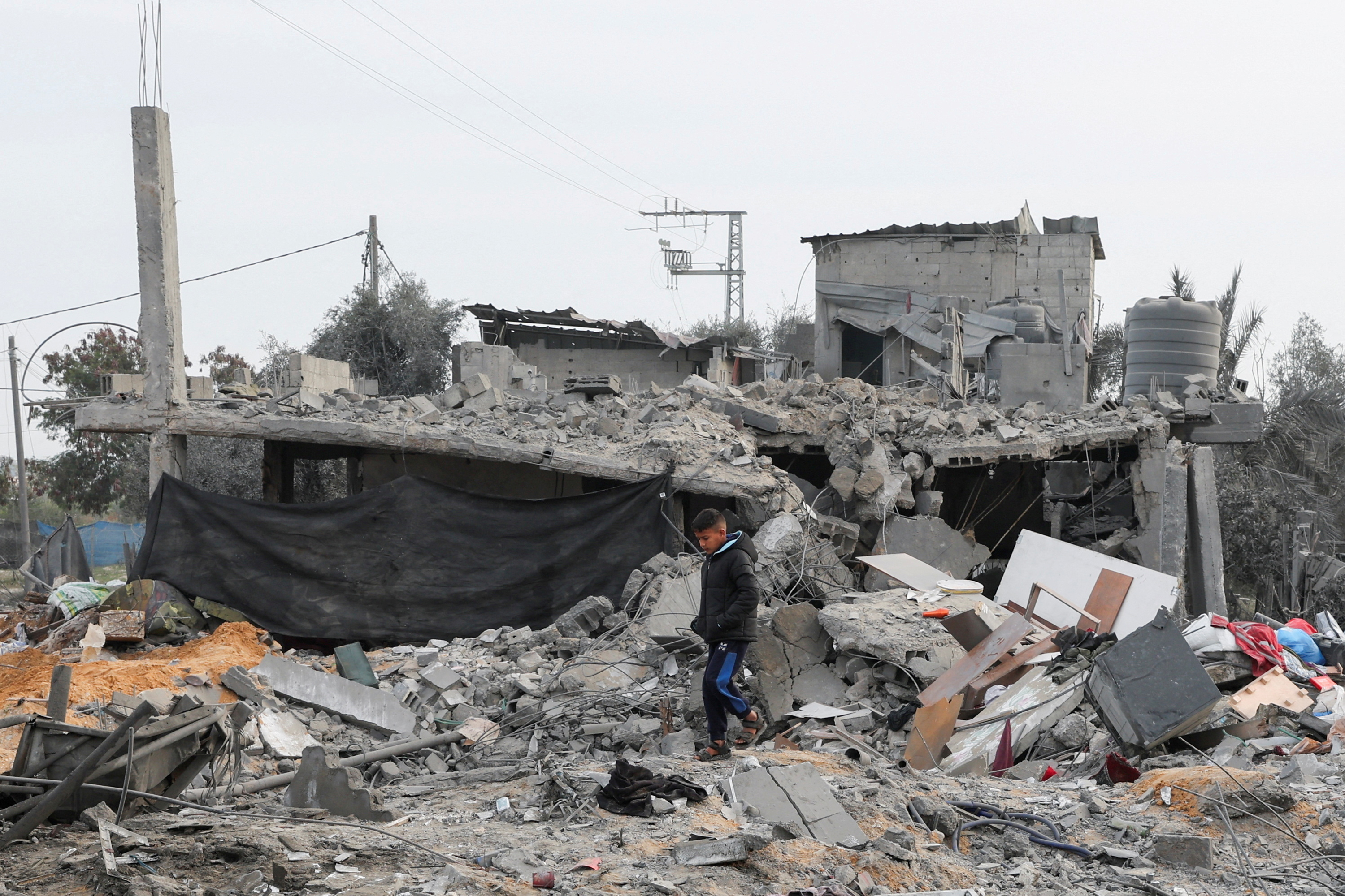 A Palestinian boy walks amidst the rubble at the site of an Israeli strike on a house, in Rafah, Gaza, on February 23.