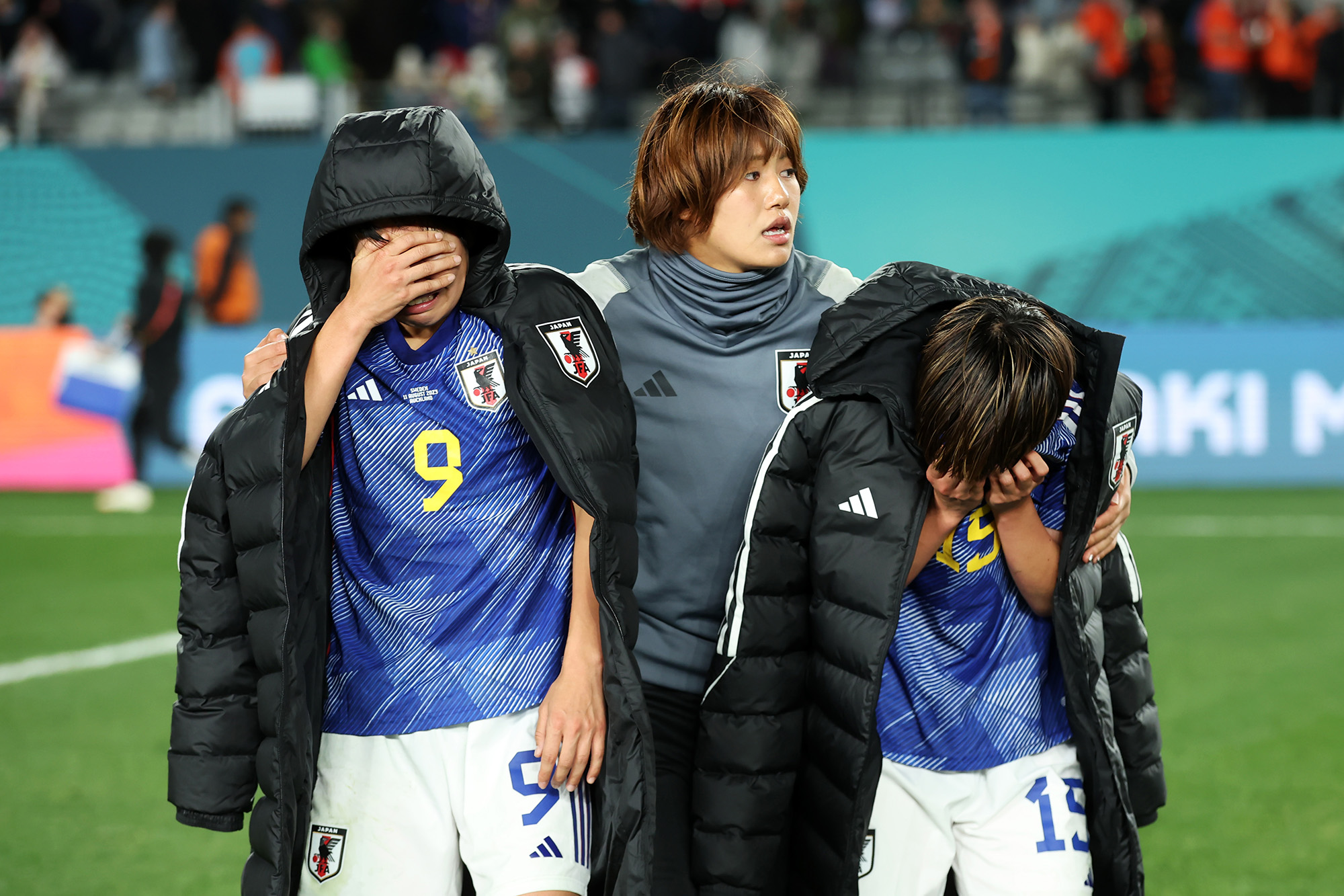 Riko Ueki and Aoba Fujino are consoled by Momoko Tanaka after the team's 2-1 loss to Sweden in the quarterfinal.