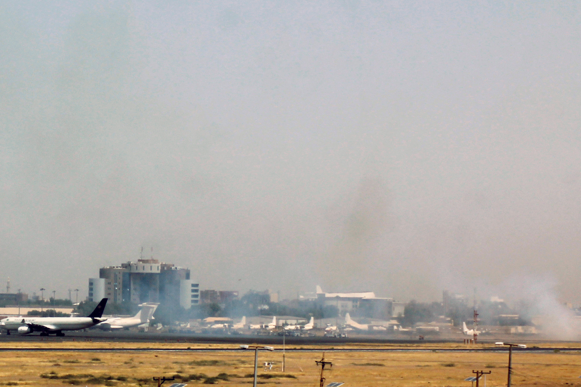 Smoke is seen on the tarmac of Khartoum's airport on April 15.
