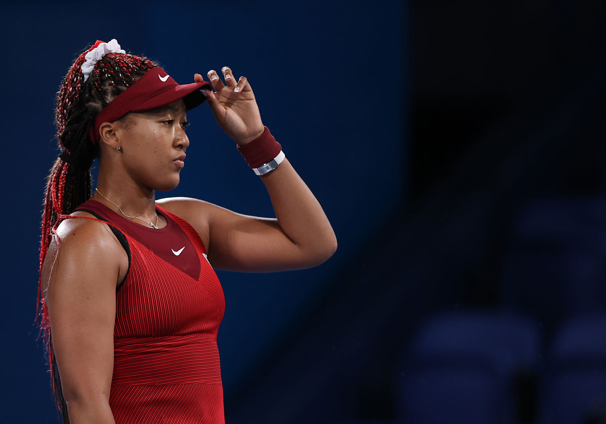 Naomi Osaka prepares to receive serve during her third round women's singles match at the Tokyo 2020 Olympic Games on July 27.