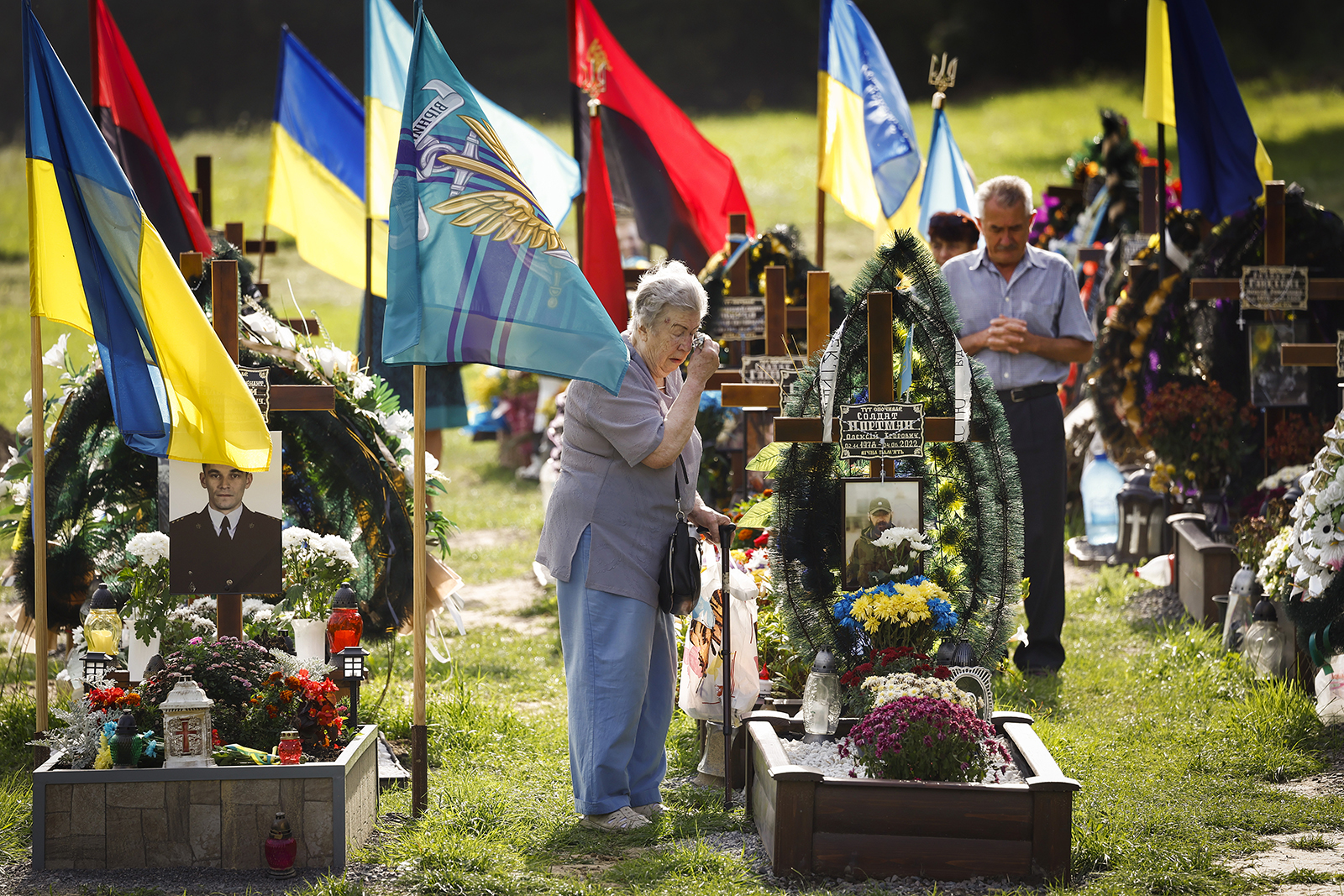 Dignitaries and families attend a ceremony for the fallen soldiers of Ukraine on the Field of Mars in Lviv, Ukraine on Aug. 24.