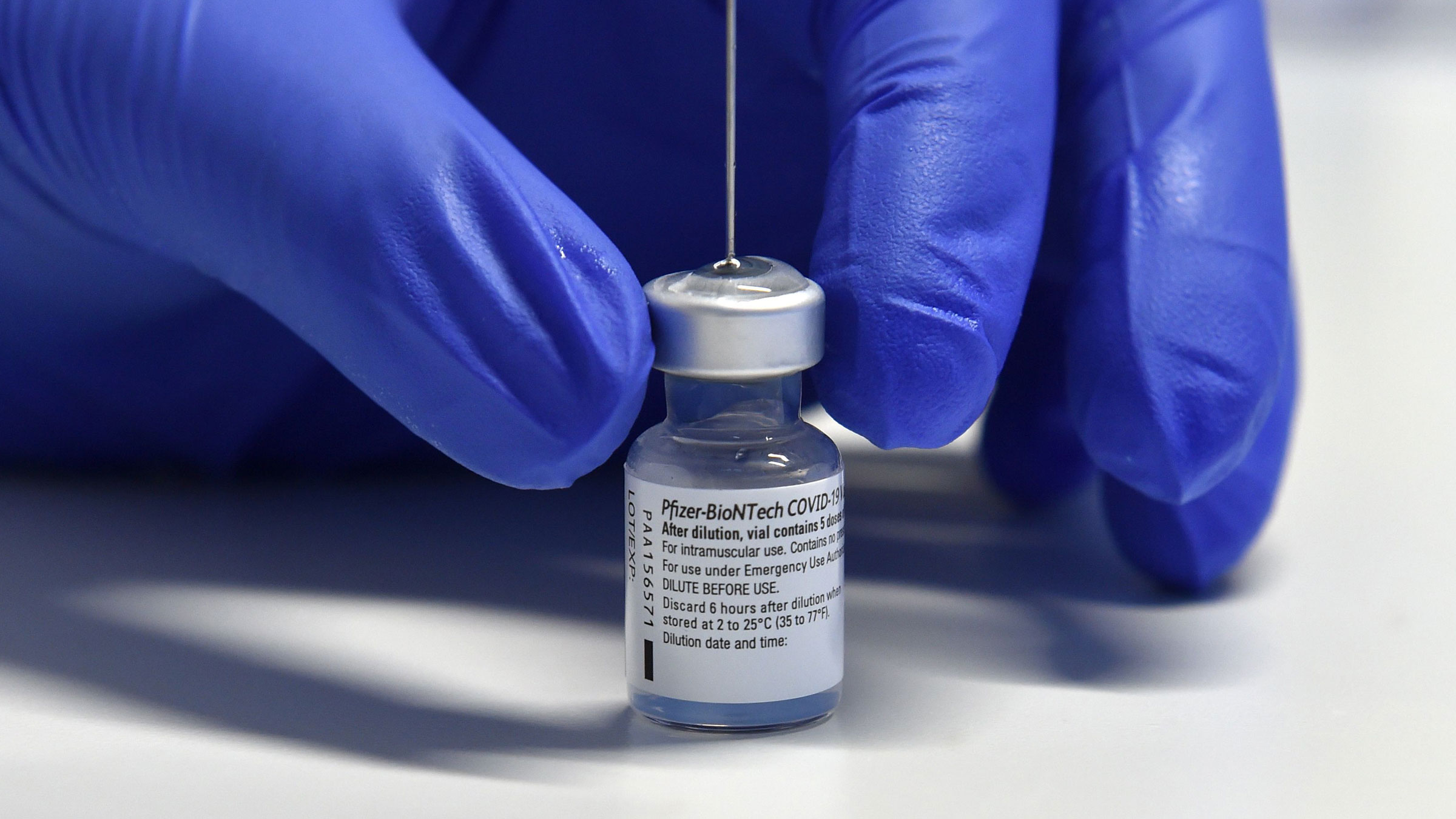 A health worker fills a syringe with the Pfizer-BioNTech Covid-19 vaccine.