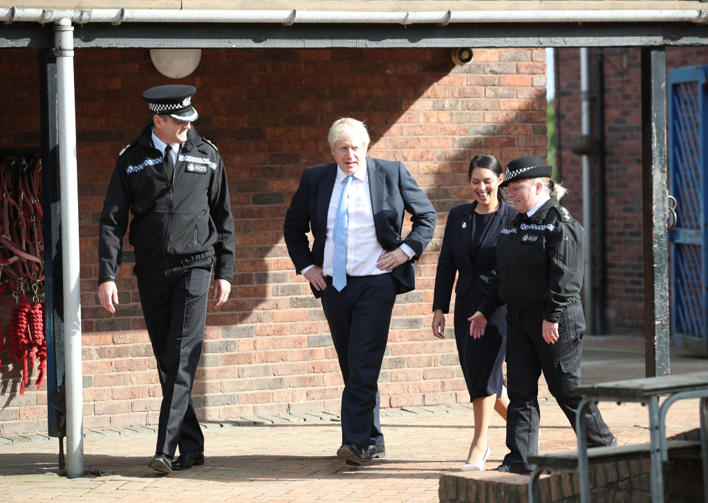 Prime Minister Boris Johnson with Home Secretary Priti Patel speak to police officers in Wakefield.