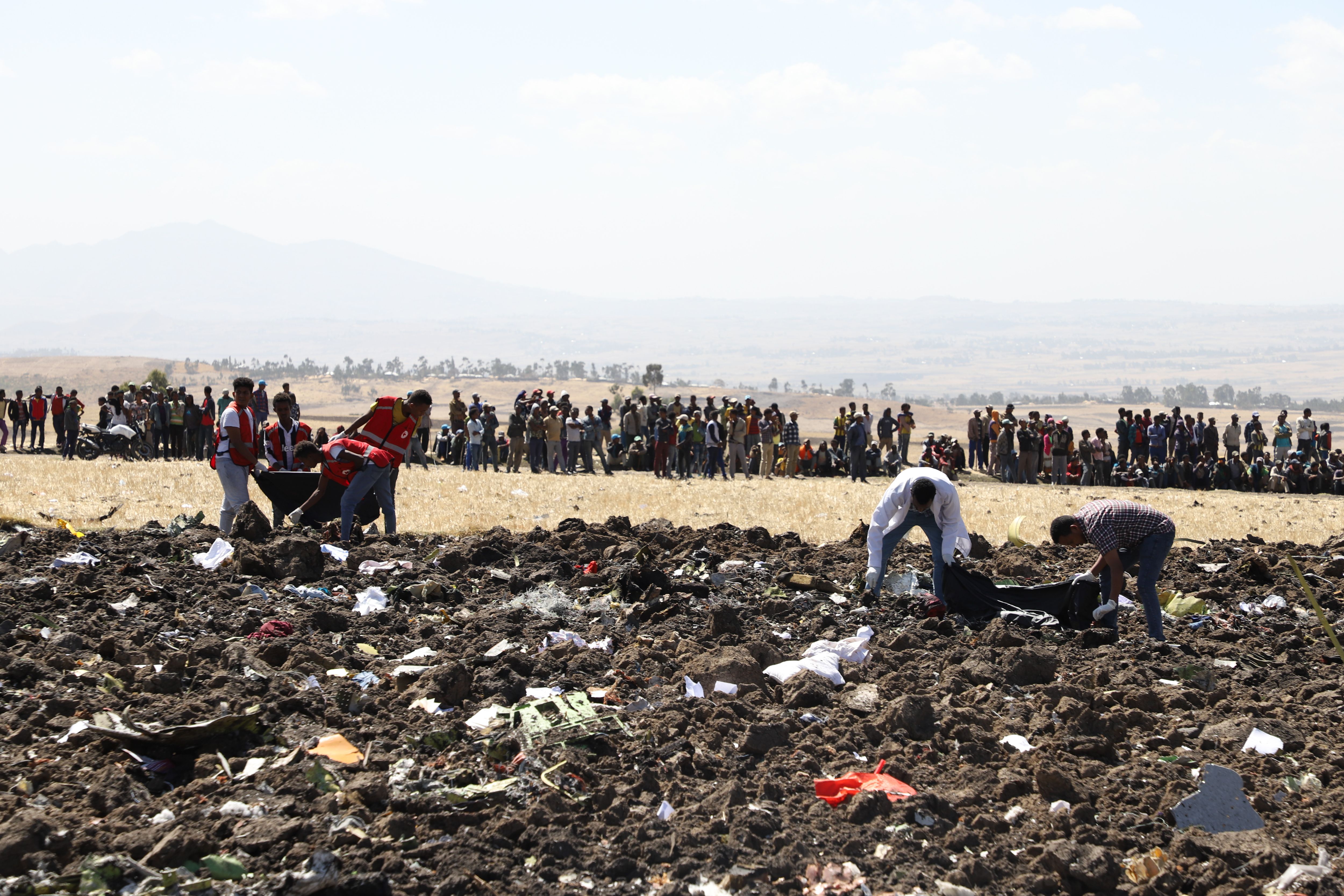 Rescue teams collect remains of bodies amid debris at the crash site of Ethiopia Airlines near Bishoftu, a town some 60 kilometres southeast of Addis Ababa, Ethiopia, on March 10, 2019.