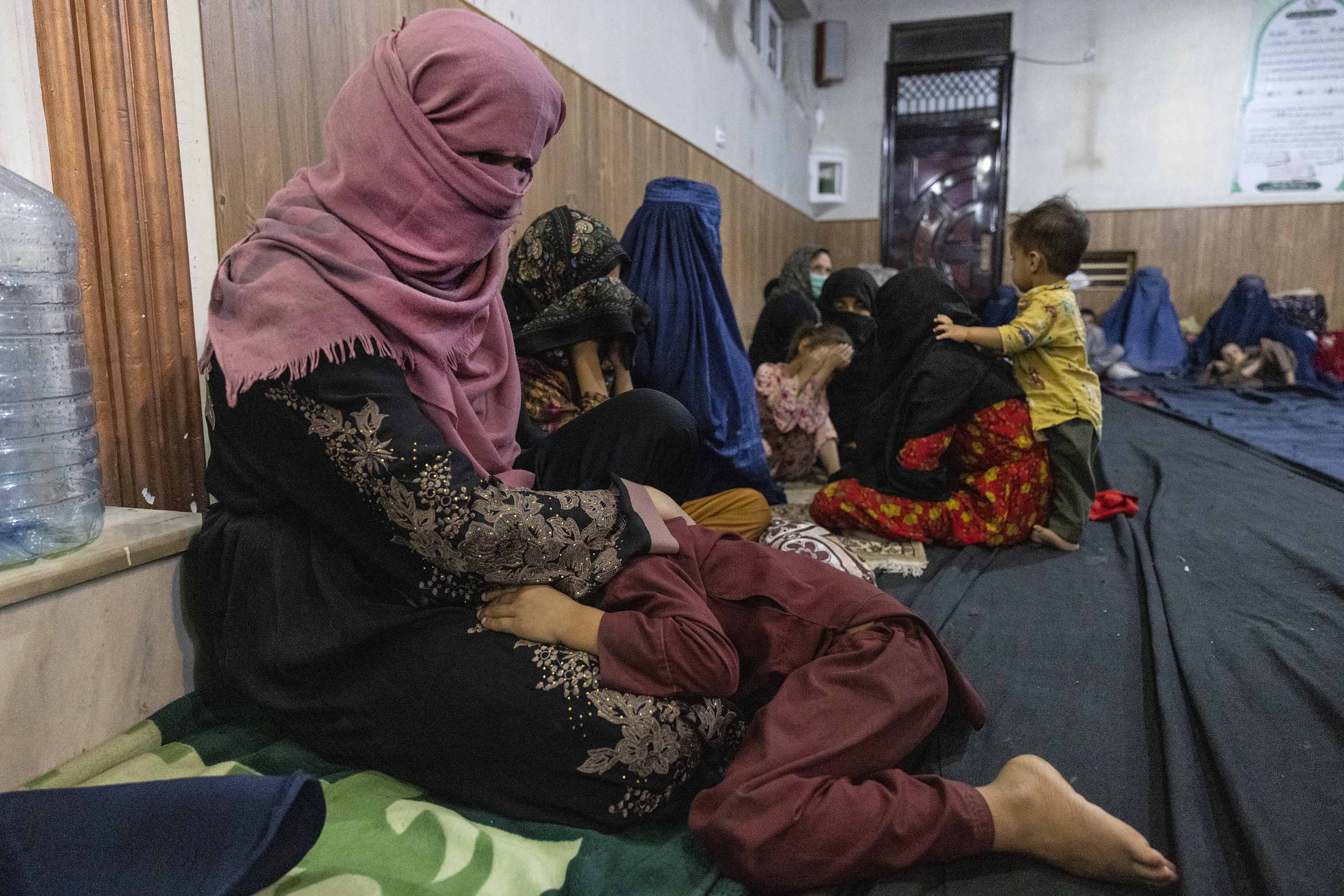 Displaced Afghan women and children from Kunduz take shelter at a mosque in Kabul on August 13. 