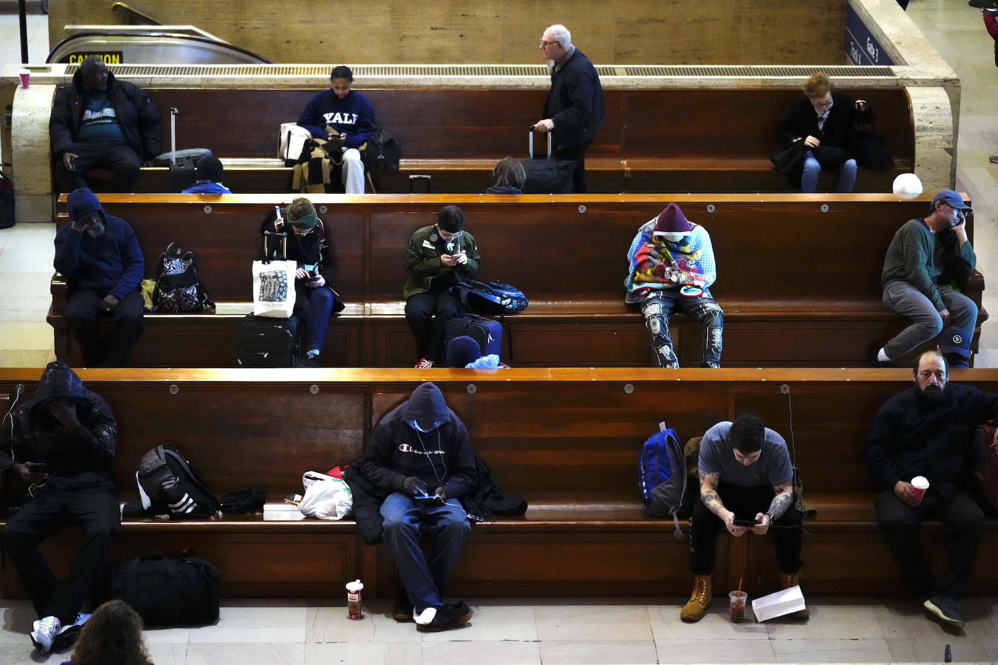 Passengers wait to board their Amtrak trains at 30th Street Station in Philadelphia on Wednesday.