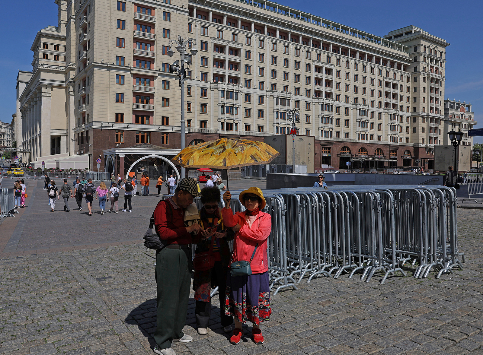 People stand near the closed Red Square in Moscow, Russia on June 25.