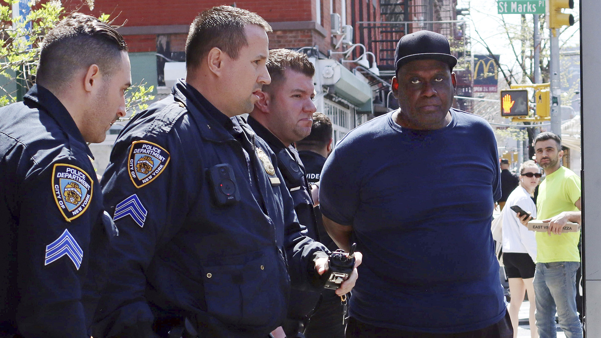 New York City Police Department officers arrest subway shooting suspect Frank R. James, 62, in the East Village section, of New York on Wednesday, April 13.