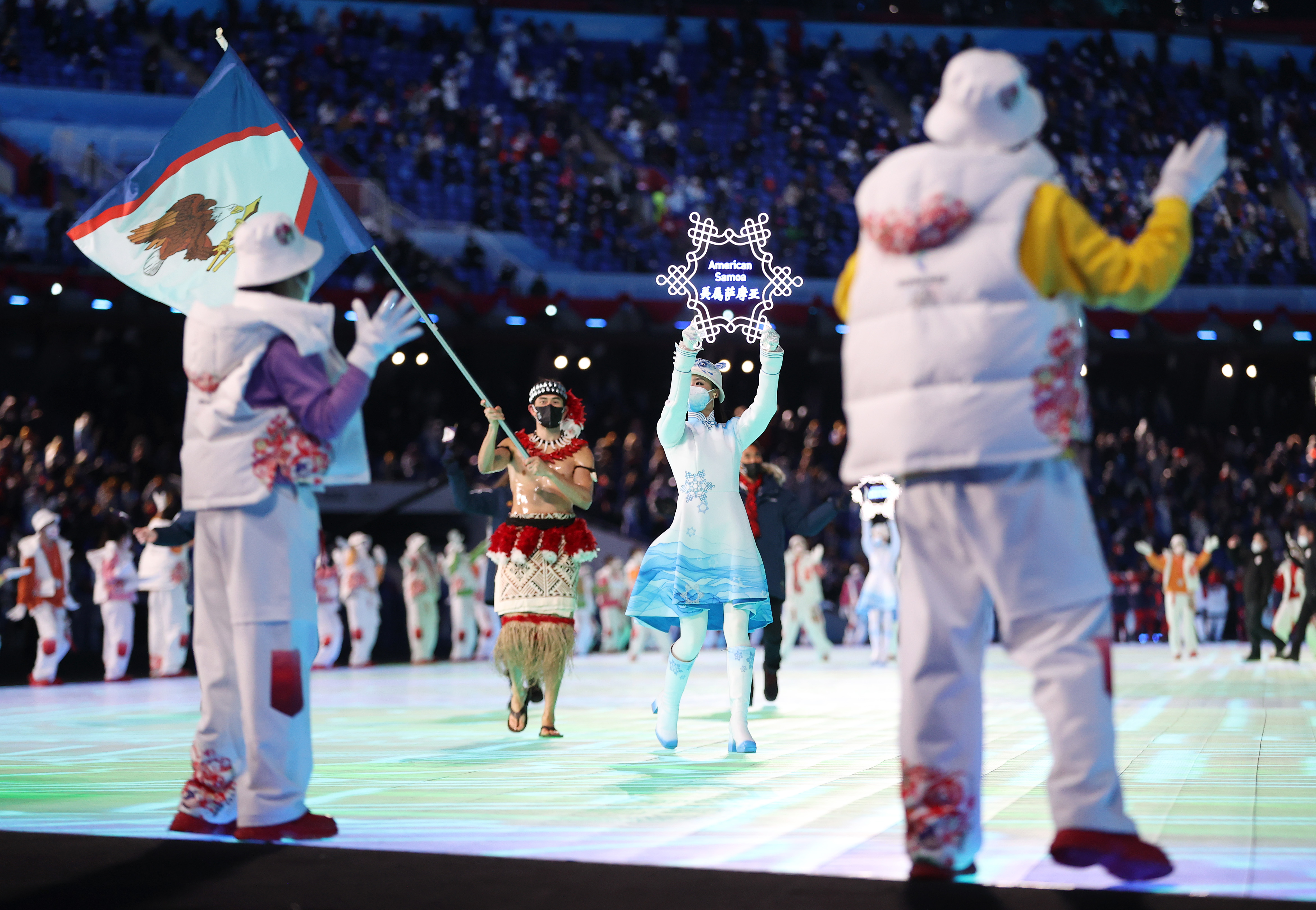 Flag bearer Nathan Crumpton of Team American Samoa carries their flag during the Opening Ceremony of the Beijing 2022 Winter Olympics at the Beijing National Stadium on February 04 in Beijing, China