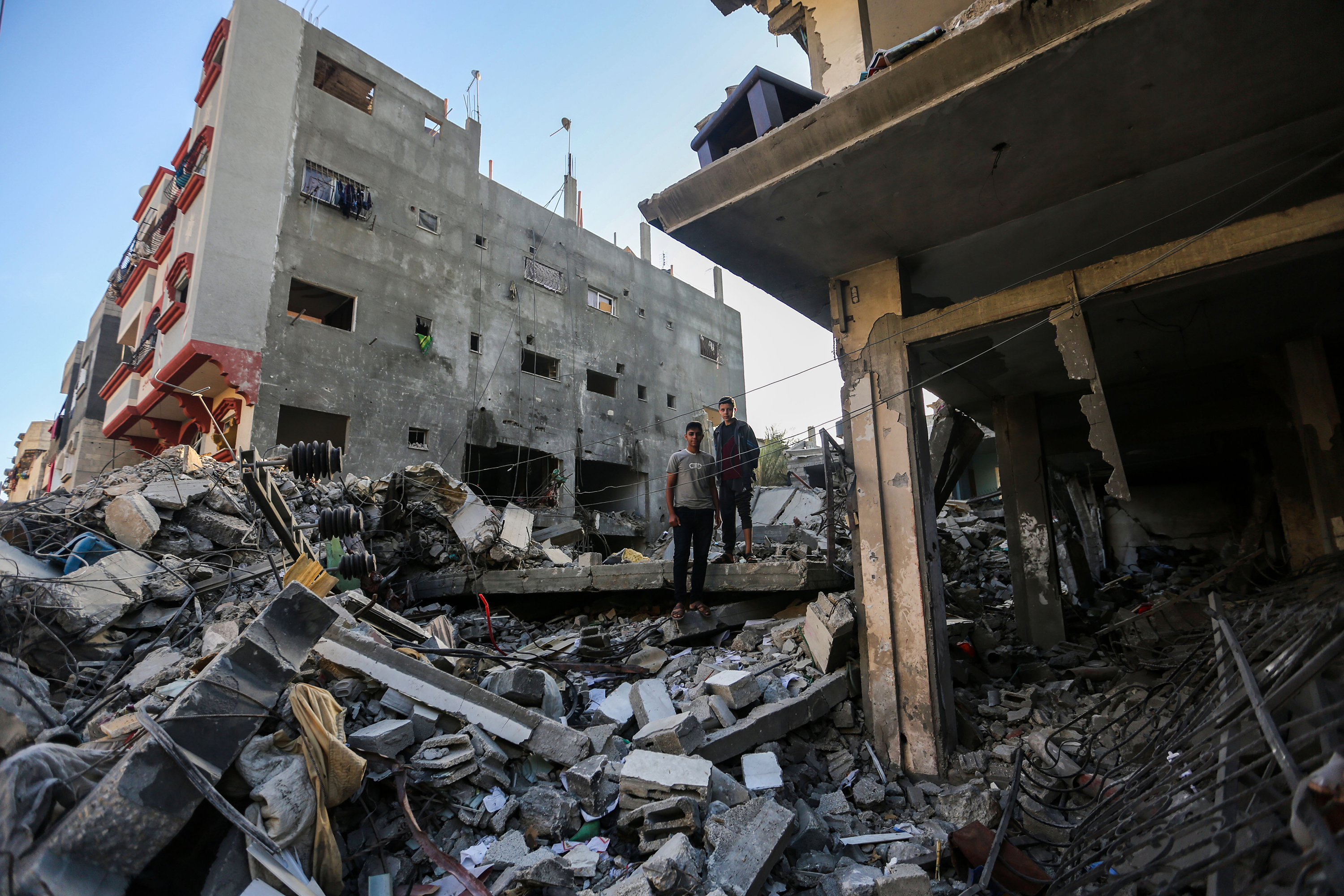 People search through destroyed buildings during Israeli air raids in the southern Gaza Strip on November 10, in Khan Yunis, Gaza.