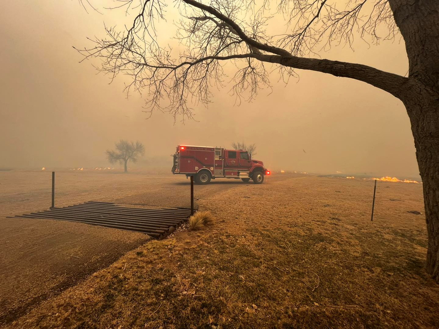 A fire engine stands amid smoke rising from wildfires in Texas on February 27.