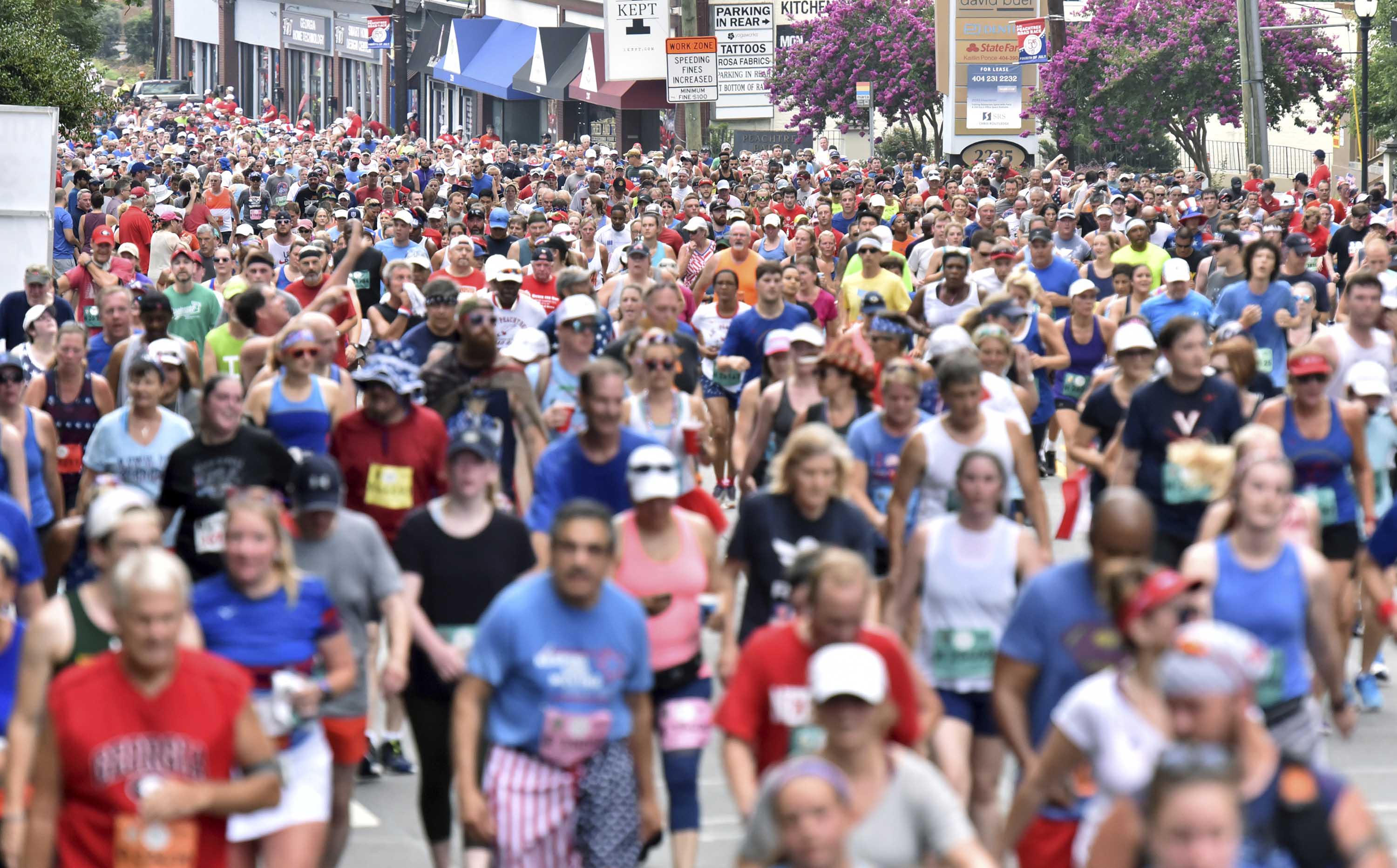 Runners make their way down Peachtree Road during the 50th AJC Peachtree Road Race on July 4, 2019.