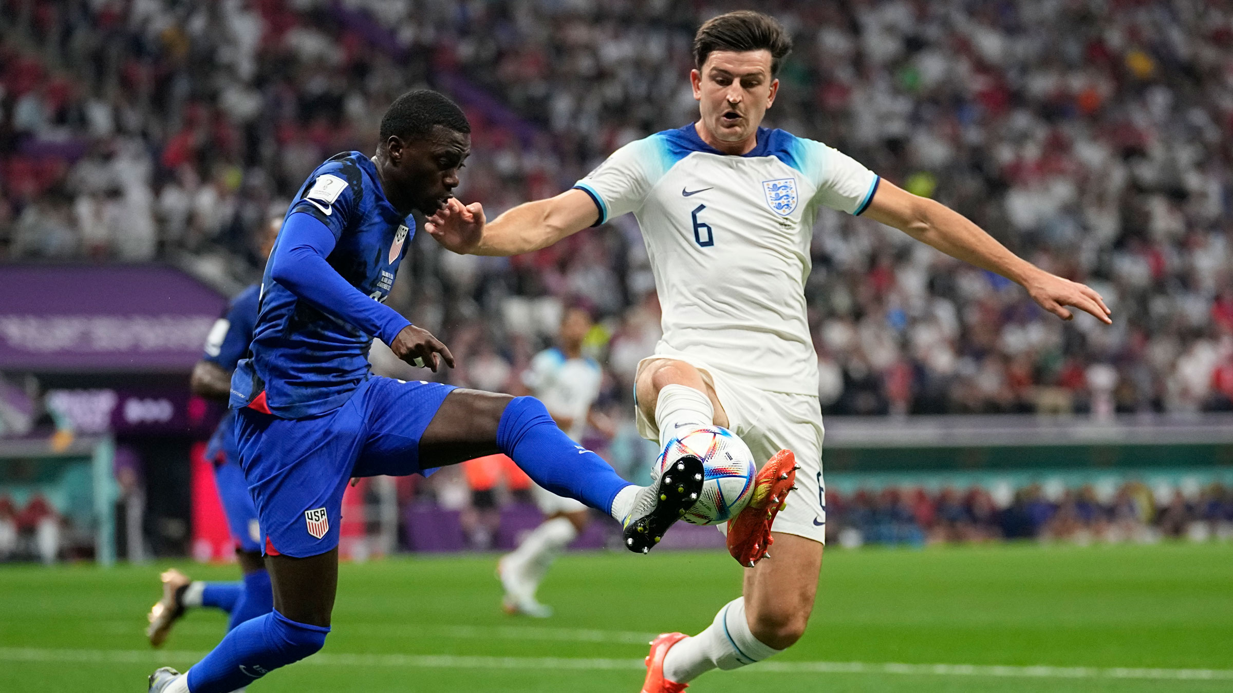 The United States' Tim Weah, left, and England's Harry Maguire fight for the ball during Friday's 0-0 draw.