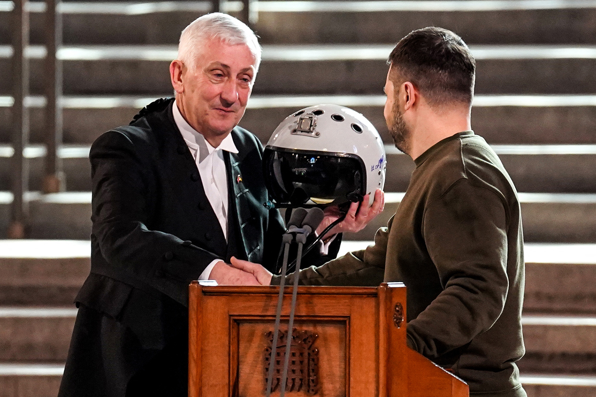 Speaker of the House of Commons, Sir Lindsay Hoyle, left, holds the helmet of one of the most successful Ukrainian pilots, inscribed with the words "We have freedom, give us wings to protect it", which was presented to him by Ukraine's President Volodymyr Zelensky inside the Palace of Westminster, on February 8.