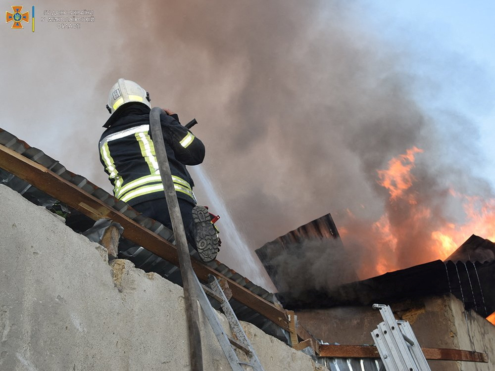 A firefighter puts out a fire at a building in Nikolaev, Ukraine, in this promotional image posted July 31. 