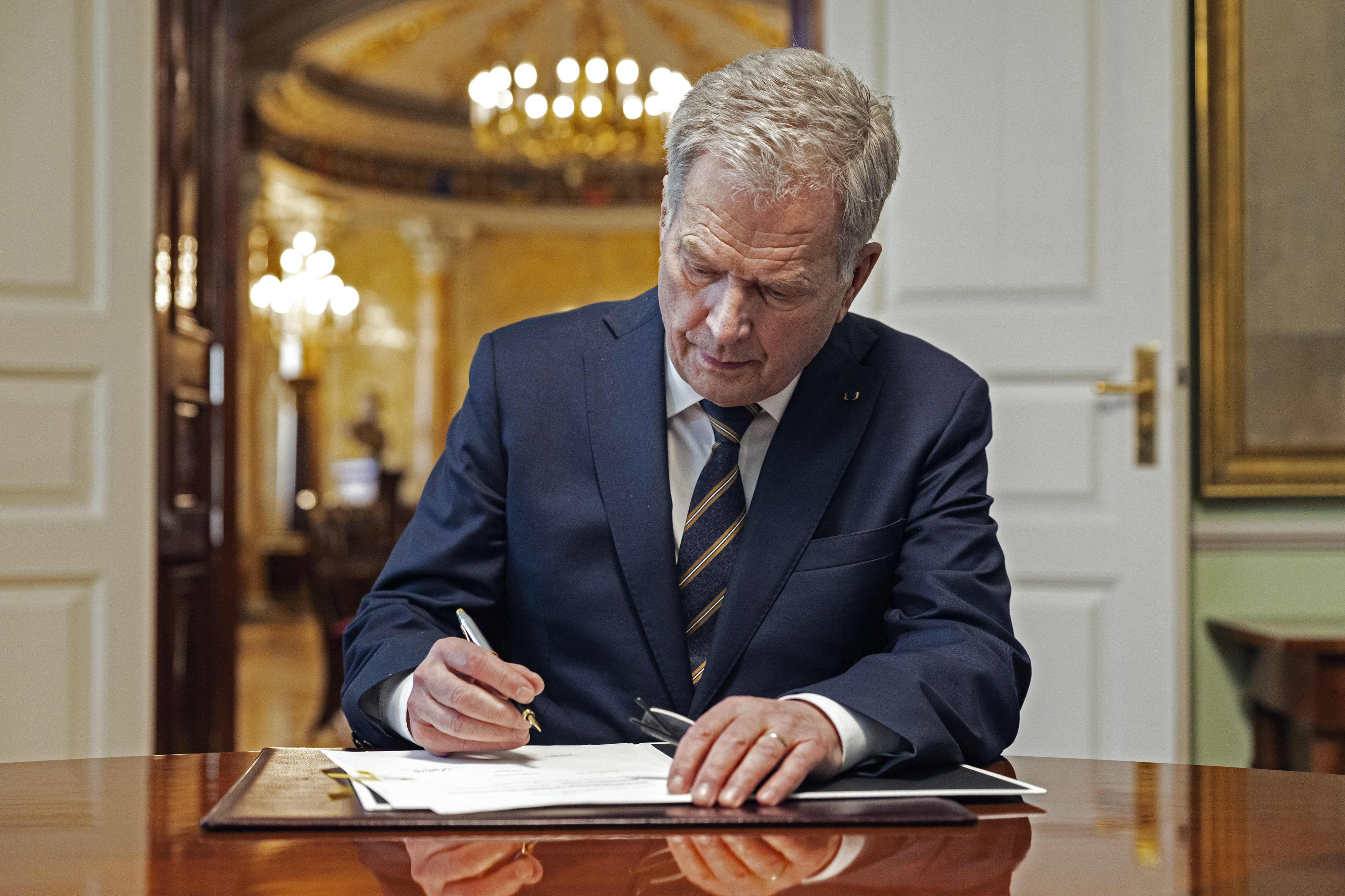 Sauli Niinistö, Finland's president, signs a domestic law which ratifies NATO treaties in Helsinki, Finland, on March 23.
