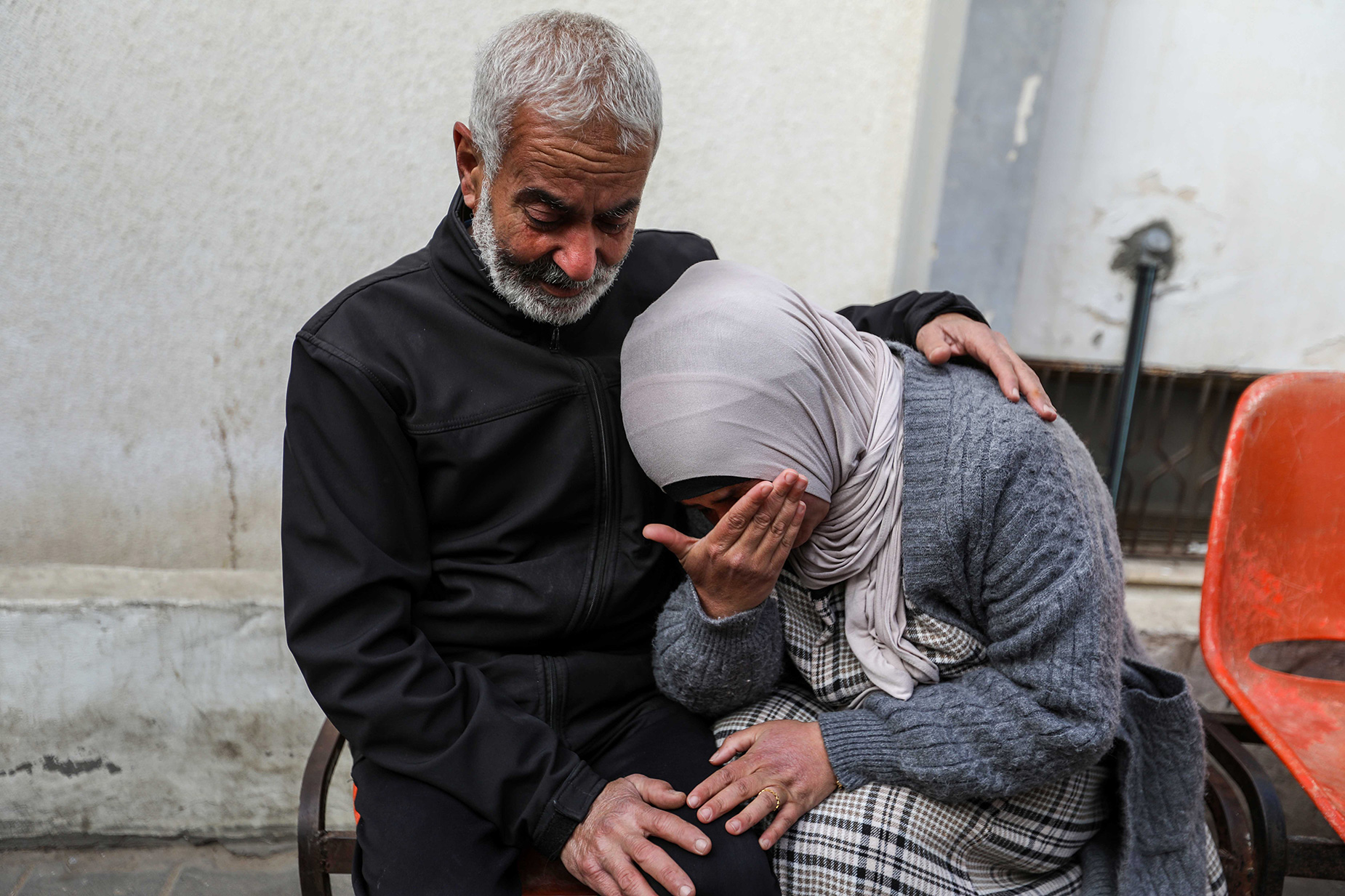 People mourn as they receive the dead bodies of victims of an Israeli strike in Rafah, Gaza, on March 26.