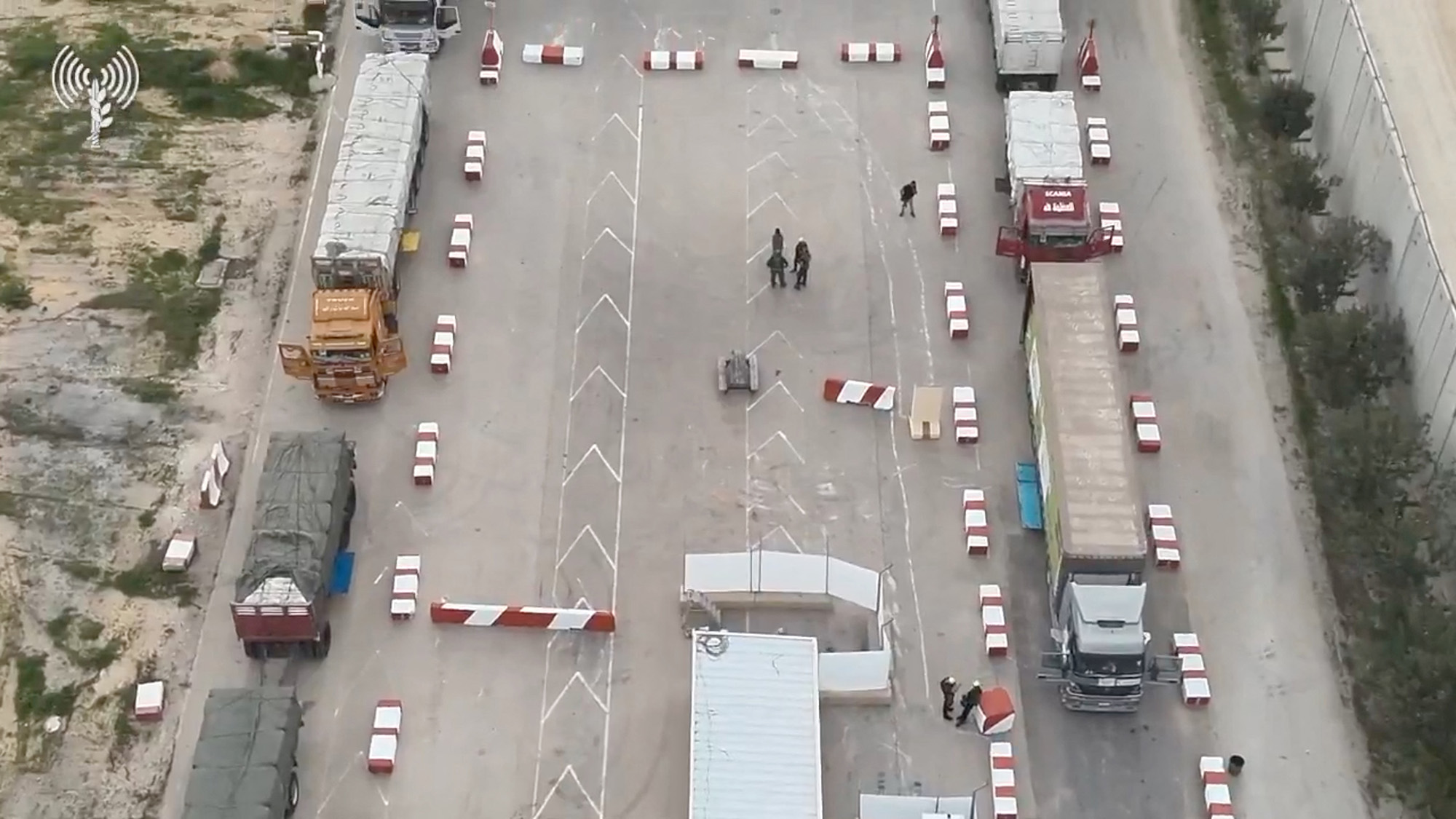 Humanitarian aid trucks wait in line to be inspected at the Kerem Shalom crossing on the border between Israel, Gaza and Egypt in this still image taken from video released on December 12.