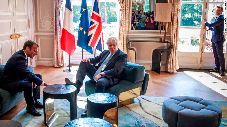 President Emmanuel Macron (L) has not changed course on Brexit, despite claims. 
