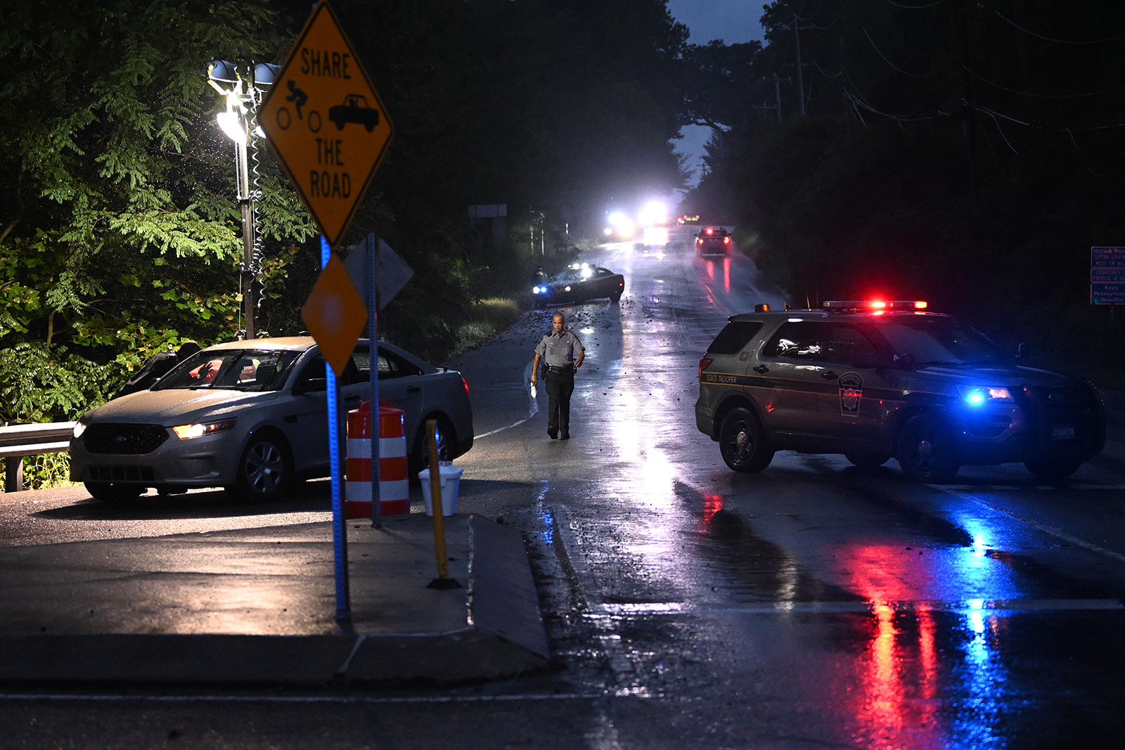 Police monitor a wooded perimeter during a manhunt for Danelo Cavalcante on September 9 in Kennett Square, Pennsylvania. 