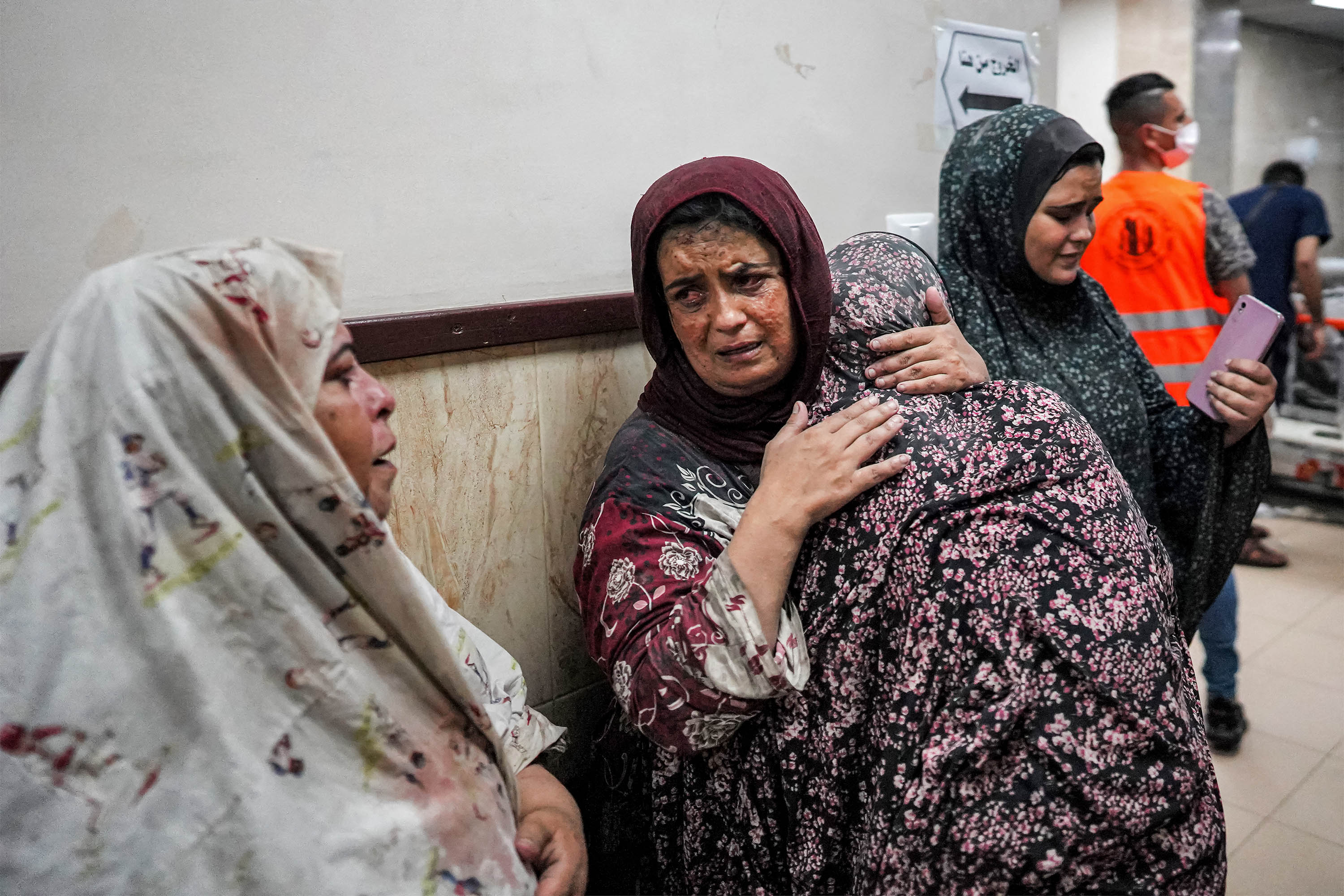 Women embrace in a corridor at a hospital in Deir el-Balah on June 4. 