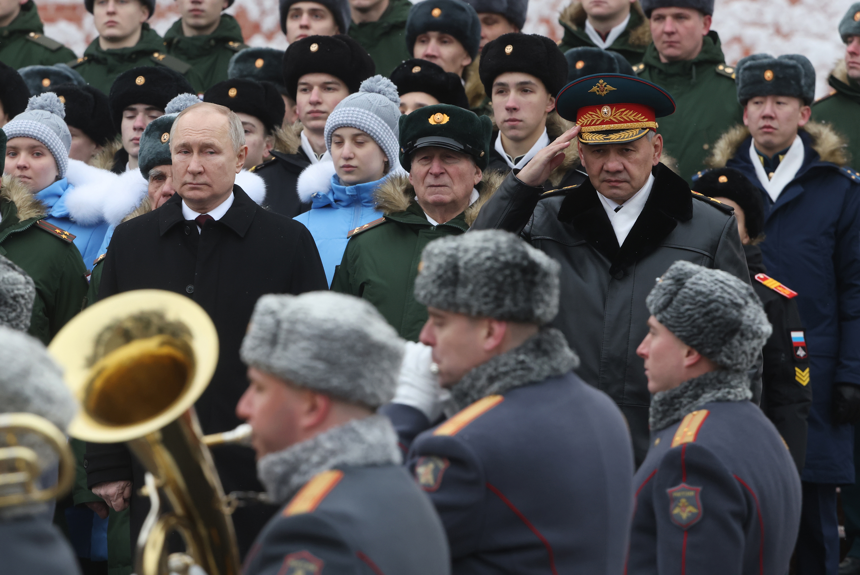 Russian President Vladimir Putin (L) and Defense Minister Sergei Shoigu (R) look on while taking part in the wreath laying ceremony at the Unknown Soldier Tomb, marking the Defender of the Fatherland's Day, on February 23, in Moscow, Russia.