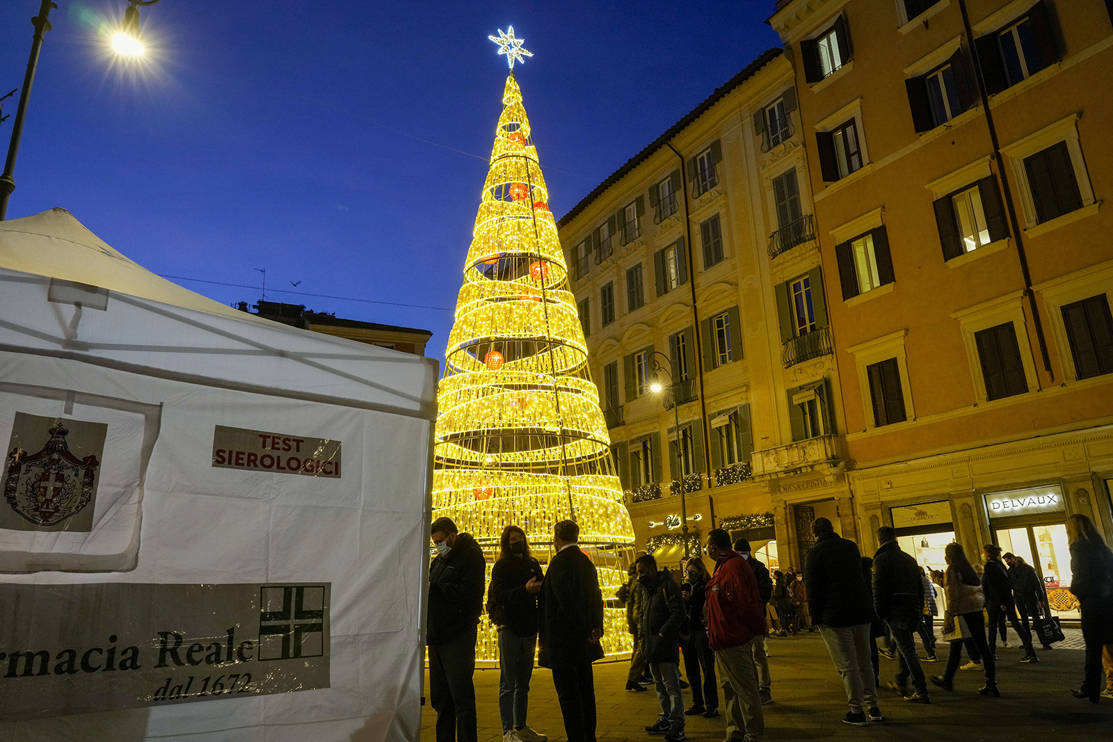 People line up at a rapid swab testing site in Rome on Thursday, Dec. 30.