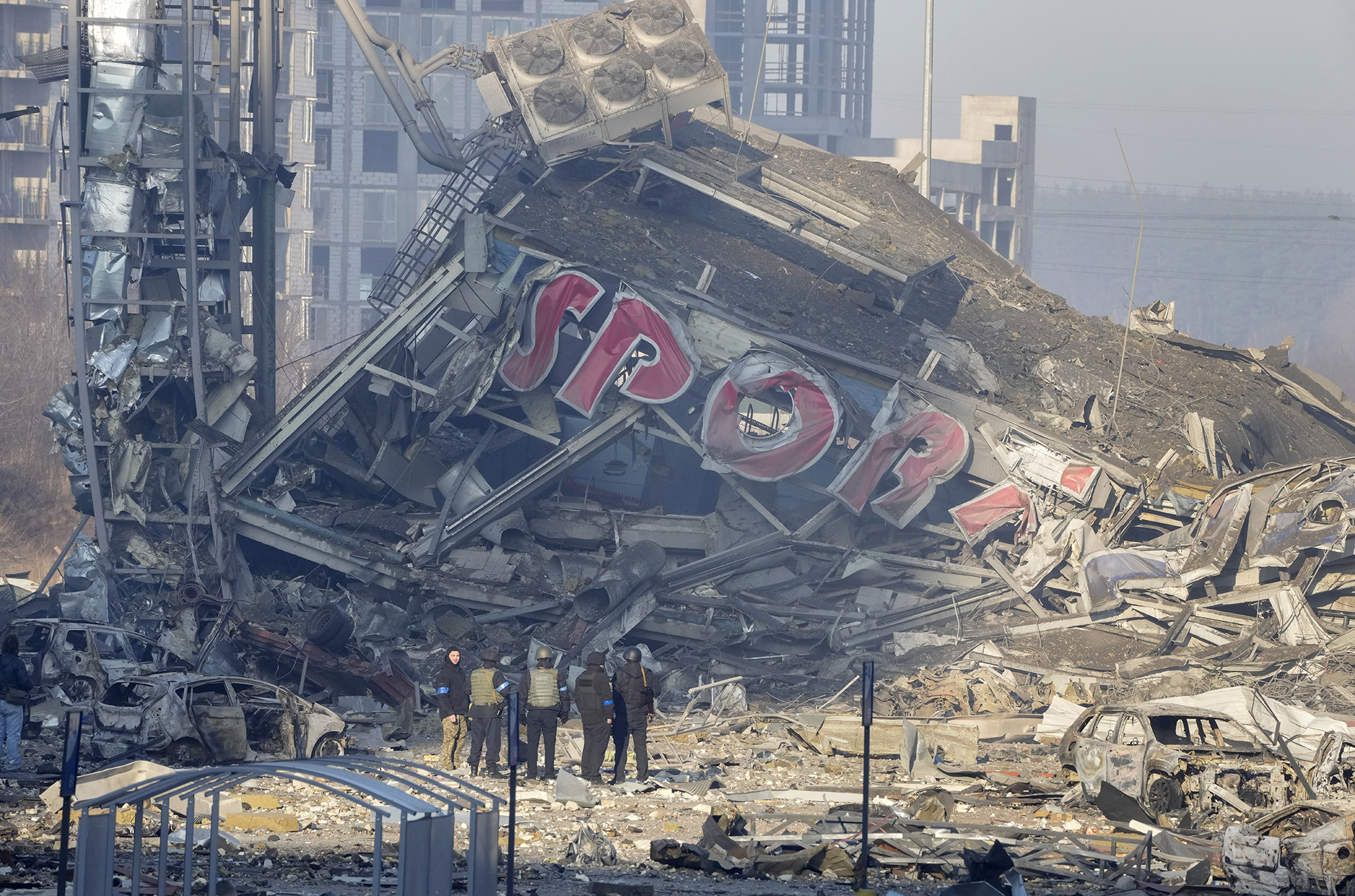 People examine the damage after shelling of a shopping center, in Kyiv, Ukraine, on March 21.