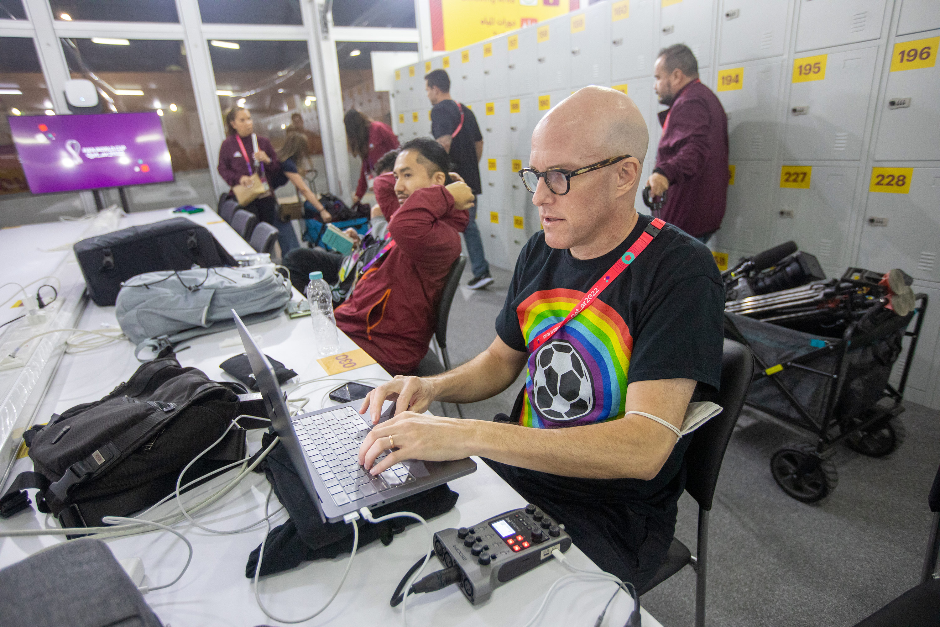 Wahl, right, works in the FIFA Media Center before a World Cup match on November 21, in Al Rayyan, Qatar.