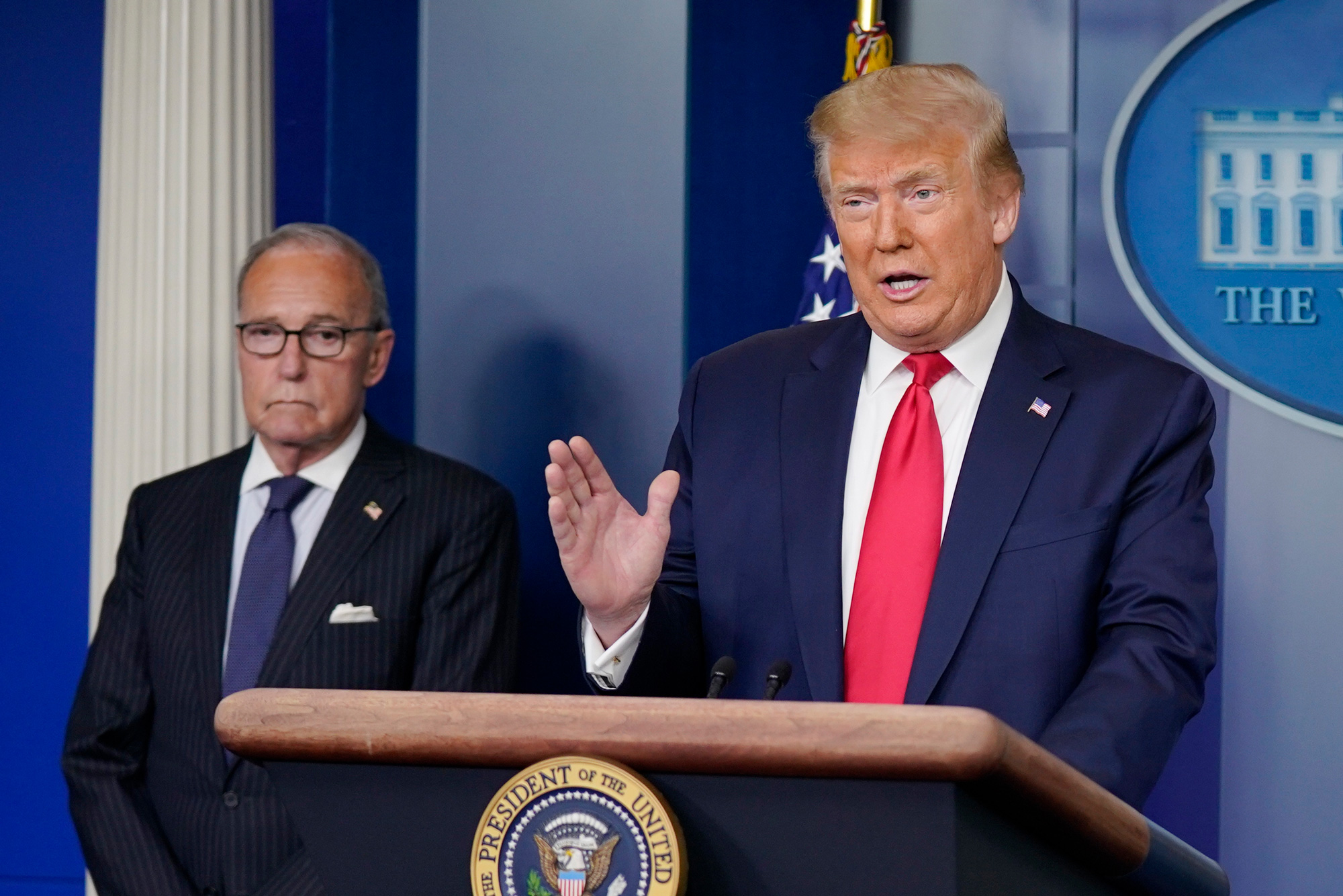 President Donald Trump speaks during a news briefing at the White House on July 2 in Washington, DC, as White House chief economic adviser Larry Kudlow looks on. 