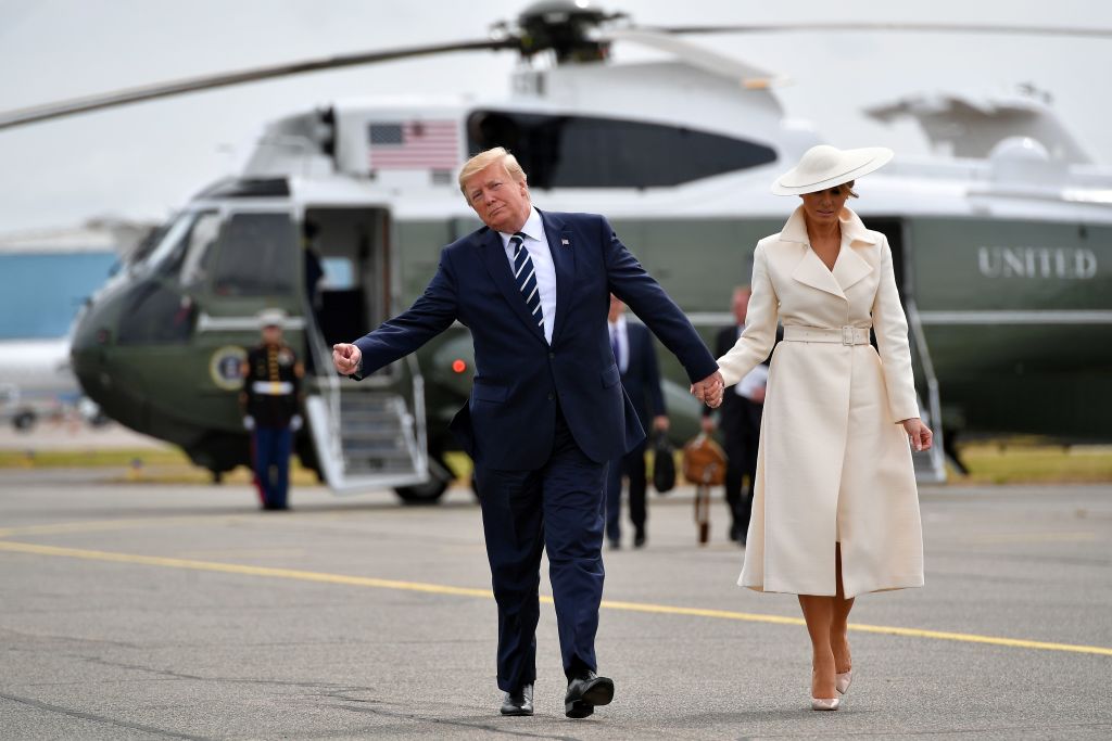 President Trump and the first lady walk off of Marine One to board Air Force One before departing from Southampton Airport, in Southampton, southern England.