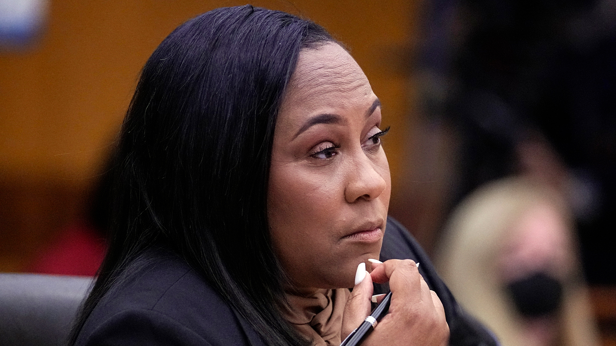 Fulton County District Attorney Fani Willis watches proceedings during a hearing to decide if the final report by a special grand jury looking into possible interference in the 2020 presidential election can be released on January 24, 2023. 