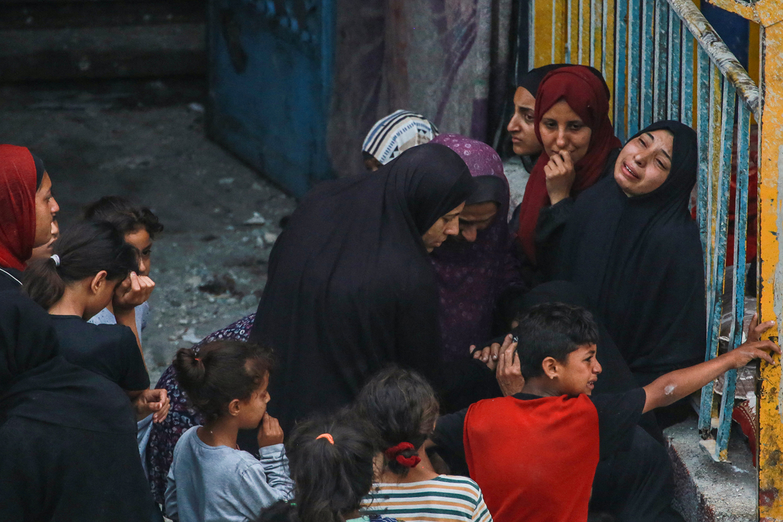Palestinians react at a UN-school housing displacing people that was hit during Israeli bombardment in Nuseirat, in the central Gaza Strip, on June 6.