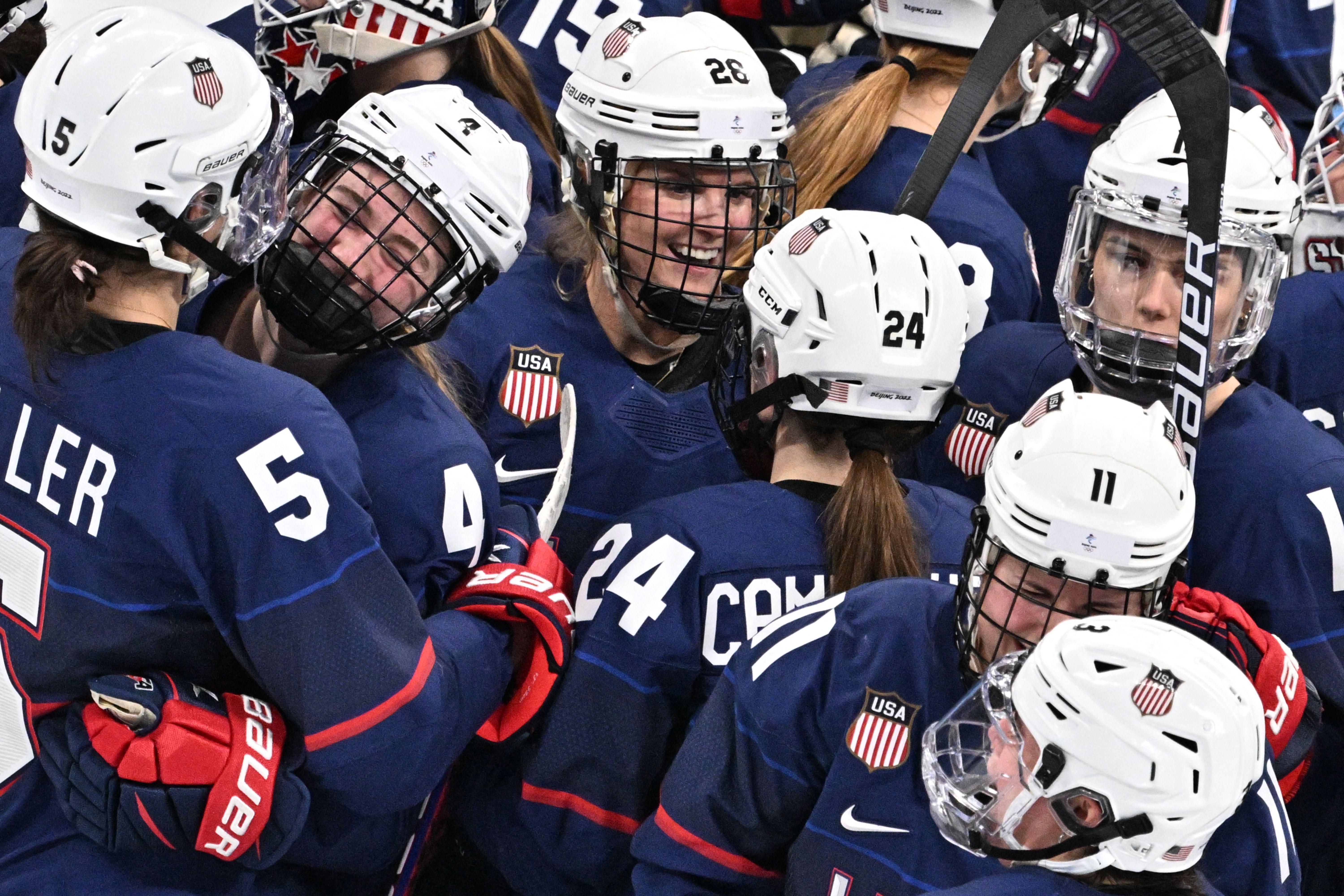 USA's Megan Keller, Caroline Harvey, Kendall Coyne Schofield and teammates celebrate winning the Beijing 2022 women's semifinal against Finland on February 14.